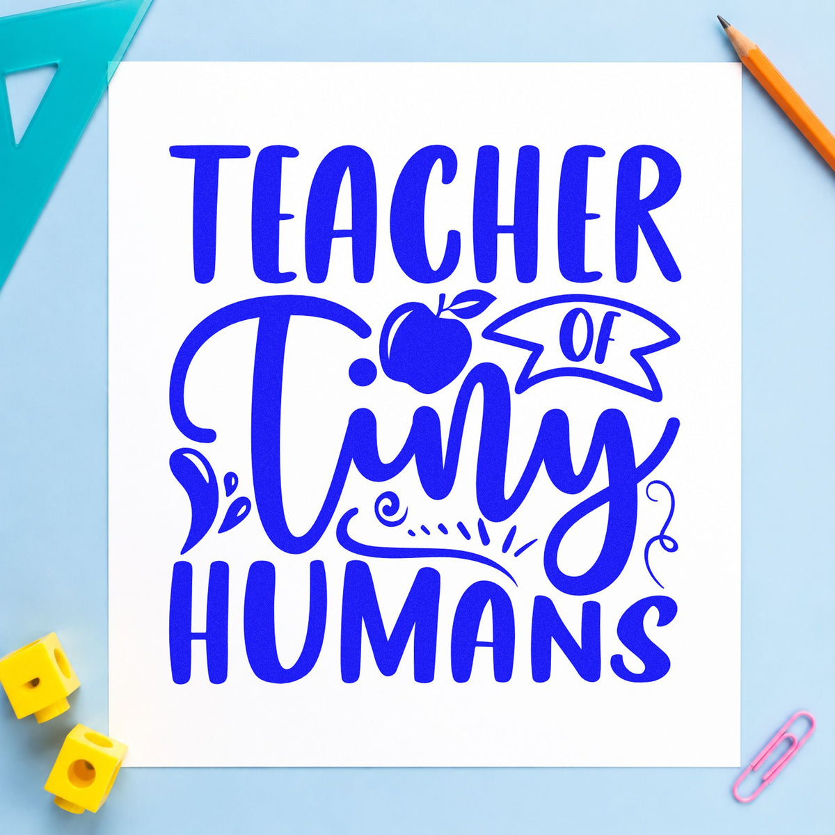 Teacher Of Tiny Humans Apple craft stamp imprinted in blue ink on paper, a design suited to gift box seals.