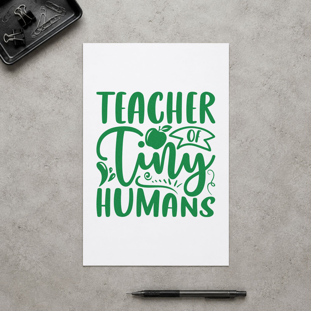 Teacher Of Tiny Humans Apple craft stamp imprint in green ink on a handmade project, one idea being framed crib wall.