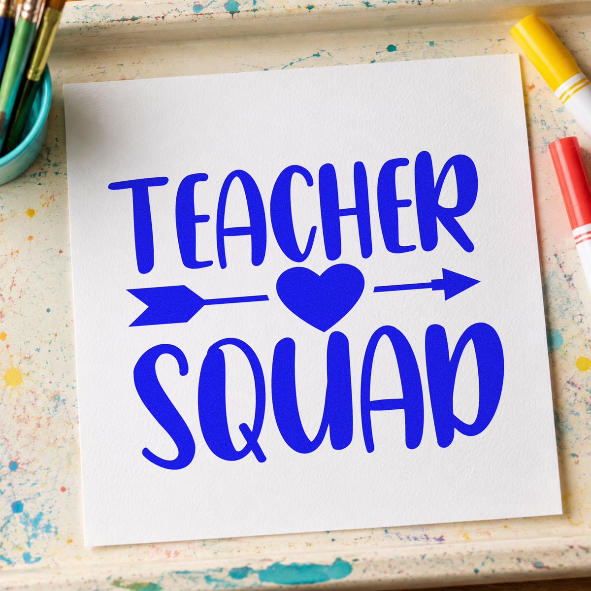 Teacher Squad Heart Arrow craft stamp in blue ink on cardstock, an easy option for cross strap panels.