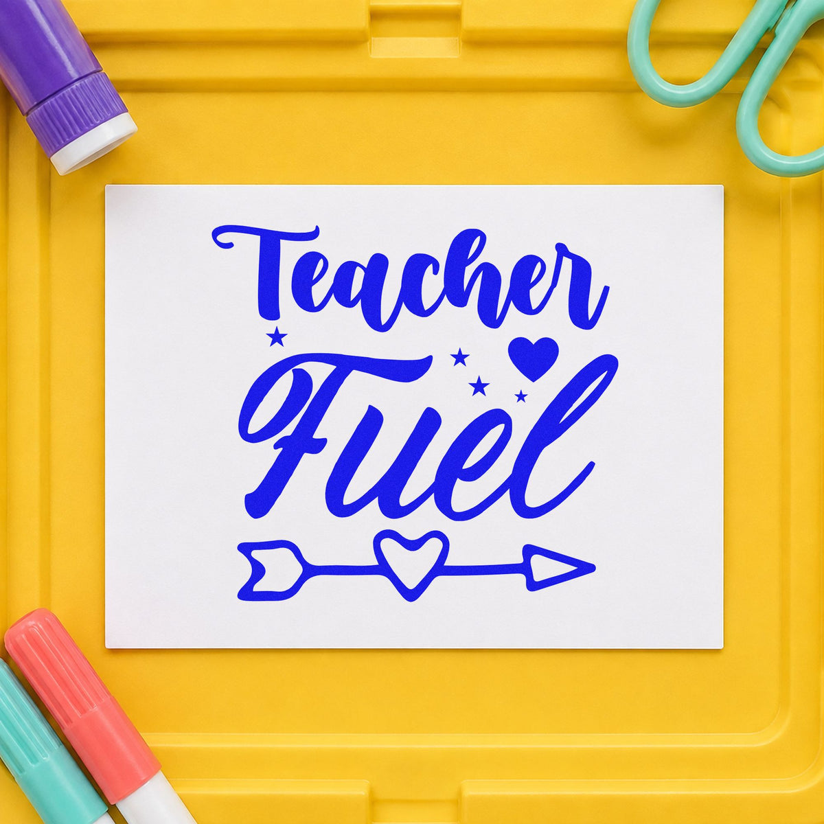 Teacher Fuel Heart Arrow craft stamp imprinted in blue ink on paper, a design suited to treat box seals.
