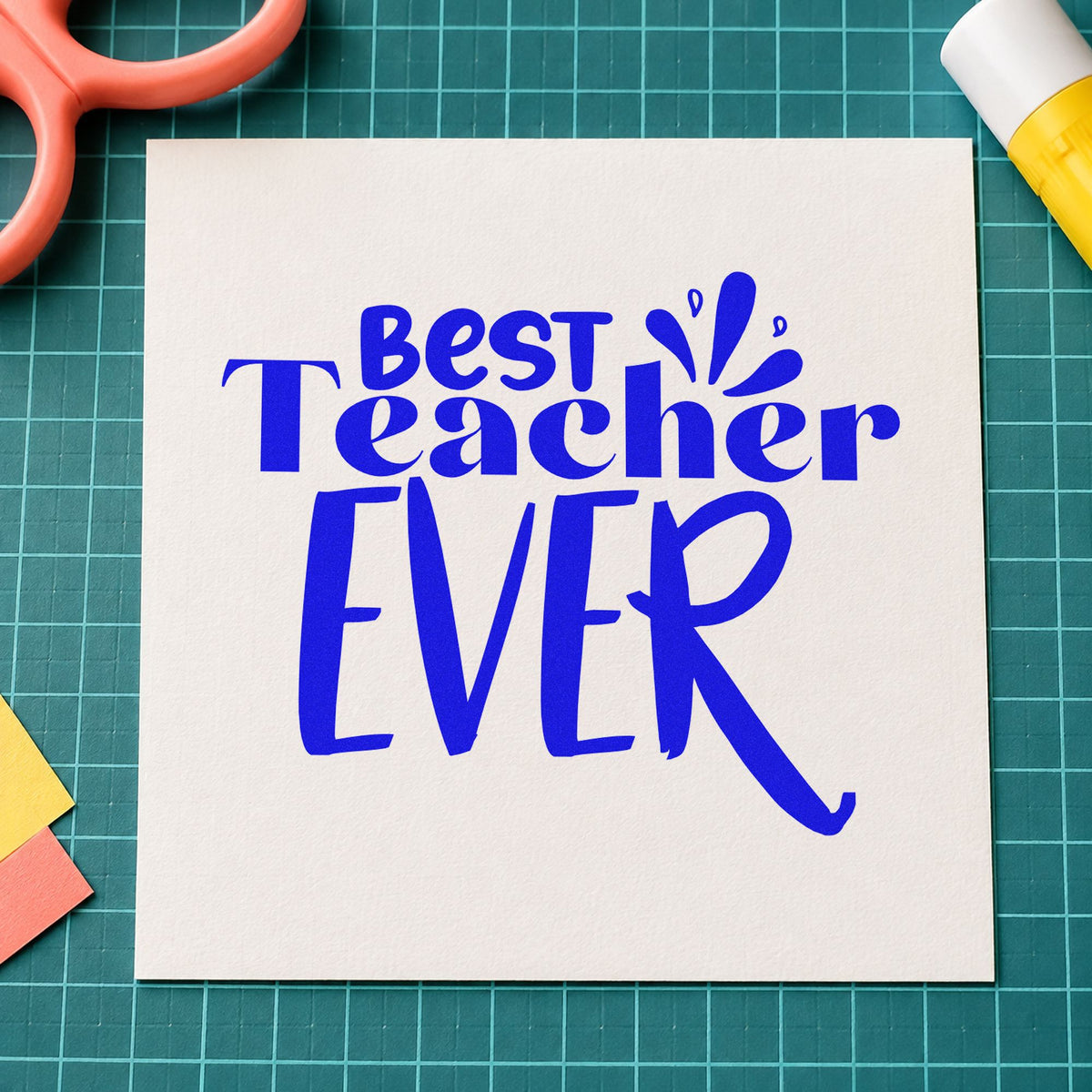 Best Teacher Ever Splash craft stamp imprinted in blue ink on paper, a design suited to zine fold seals.