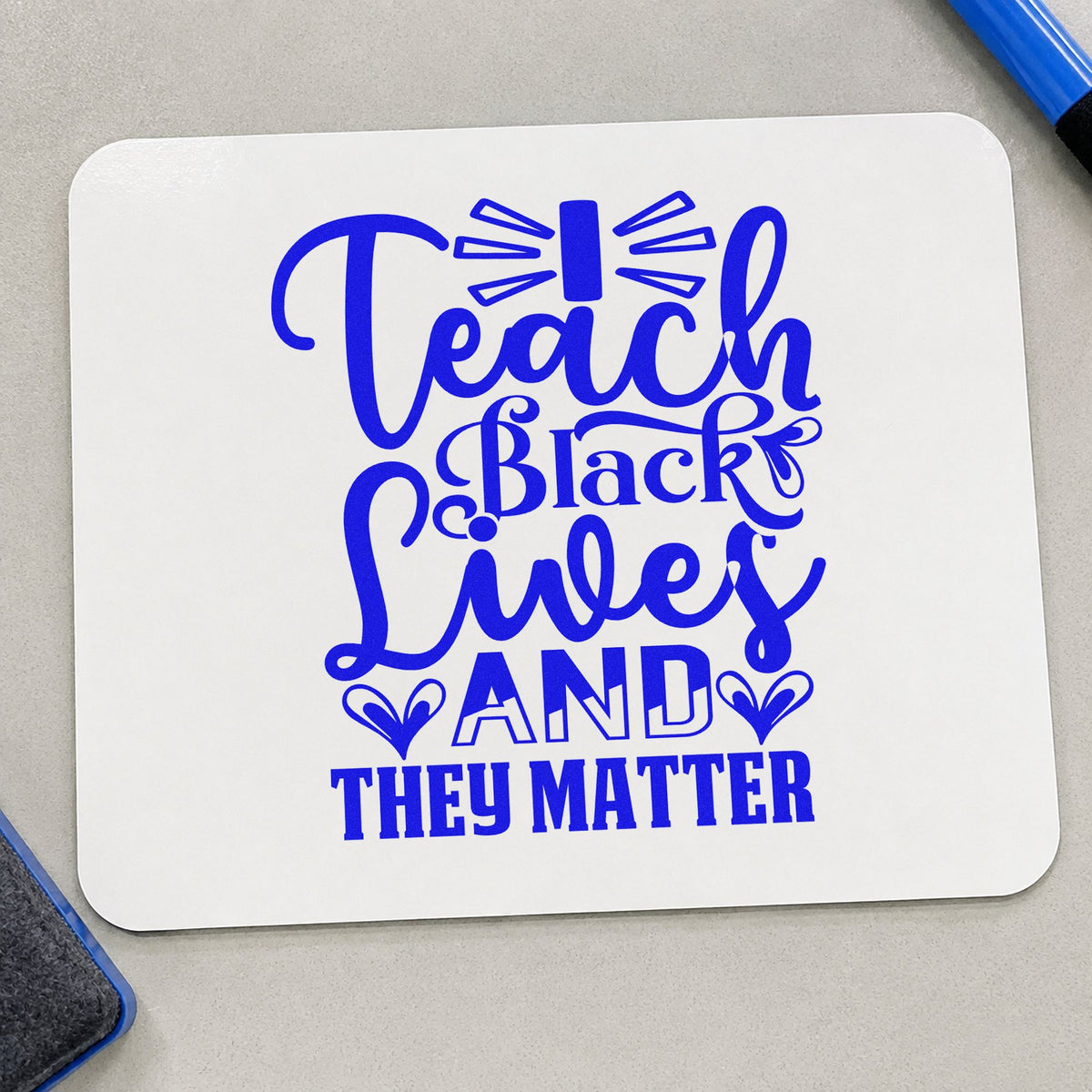 Teach Black Lives Matter craft stamp imprinted in blue ink on paper, a design suited to program seals.