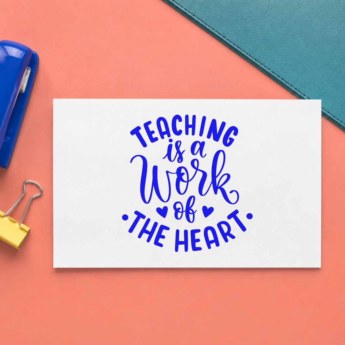 Teaching Work Of The Heart craft stamp imprinted in blue ink on paper, a design suited to fan fold seals.