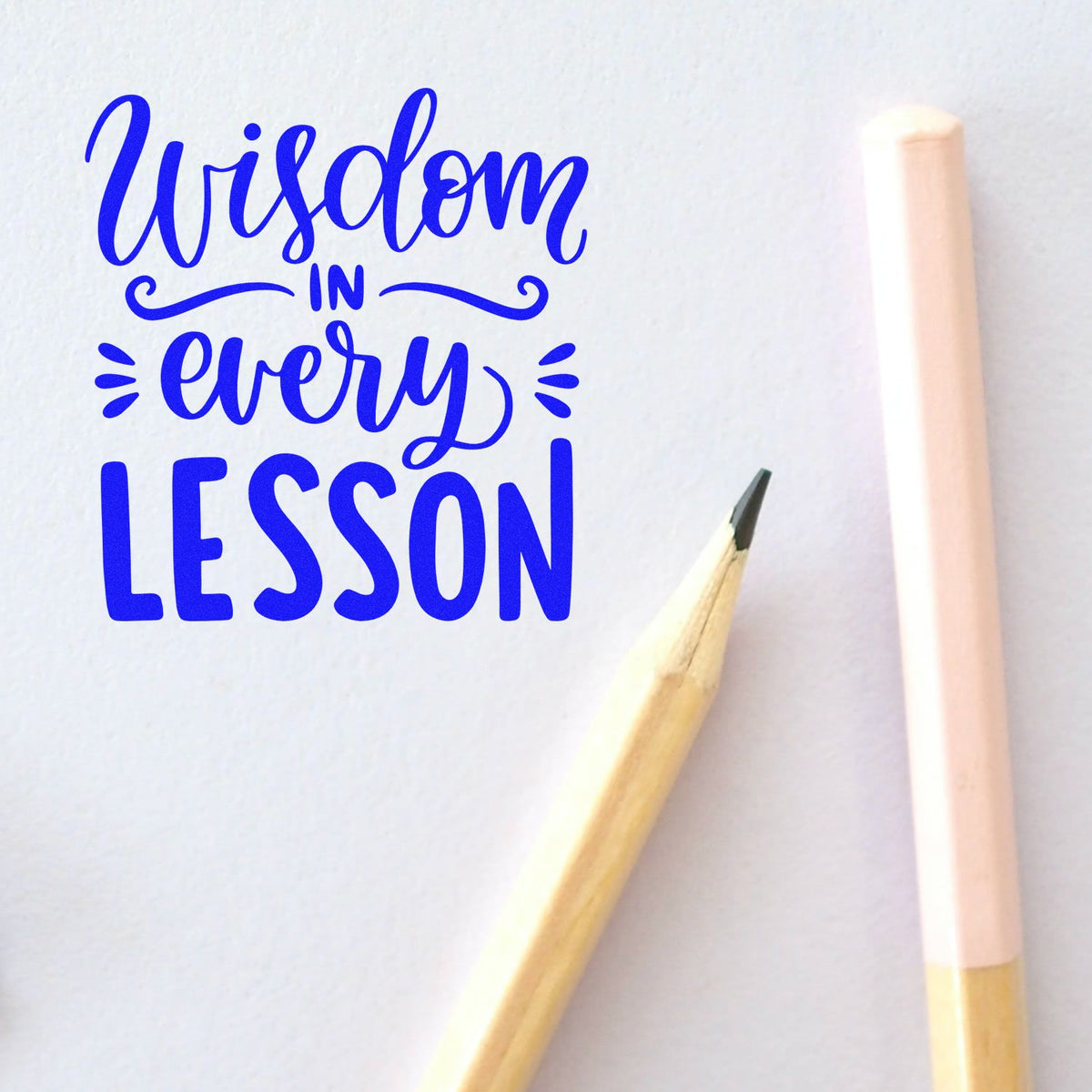 Wisdom In Every Lesson rubber stamp shown in blue ink, stamped for projects such as scheme folder tags.