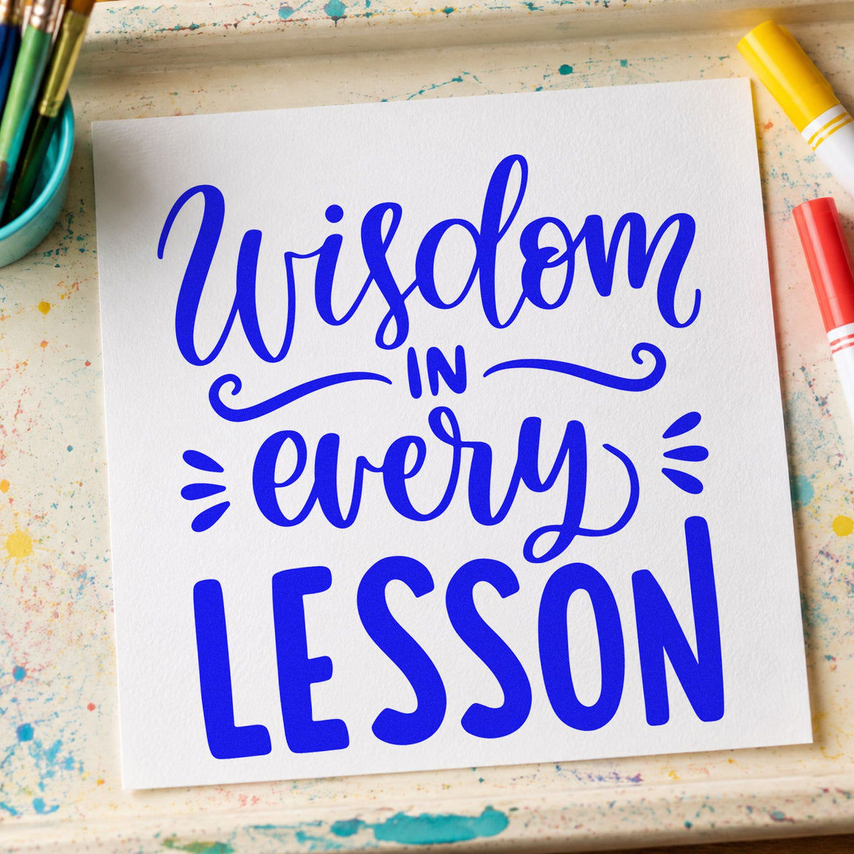 Wisdom In Every Lesson craft stamp imprinted in blue ink on paper, a design suited to moderation seals.