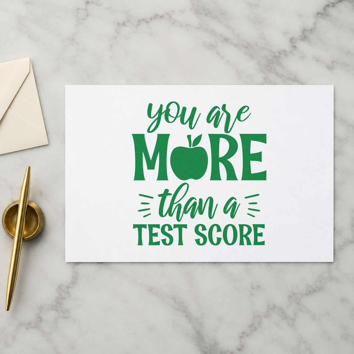 More Than A Test Score craft stamp imprint in green ink on a handmade project, one idea being framed advice room.