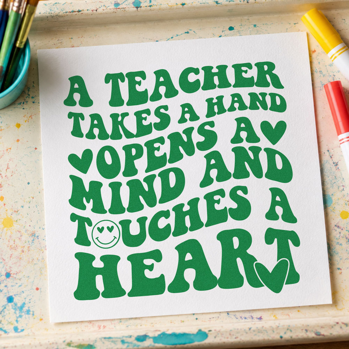 Teacher Takes Hand Touches Heart craft stamp imprint in green ink on a handmade project, one idea being framed shared corner.