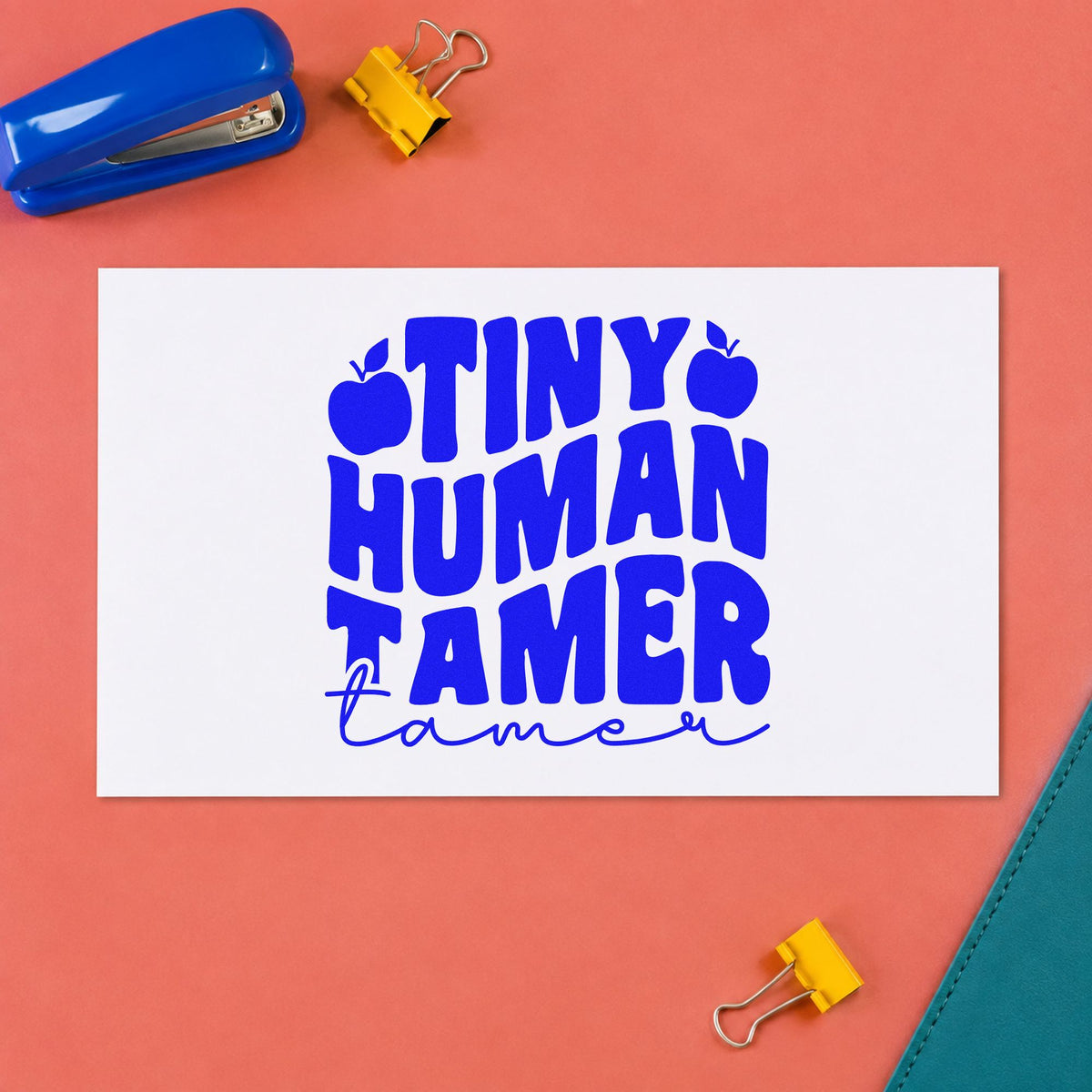 Tiny Human Tamer Apples craft stamp imprinted in blue ink on paper, a design suited to party bag seals.