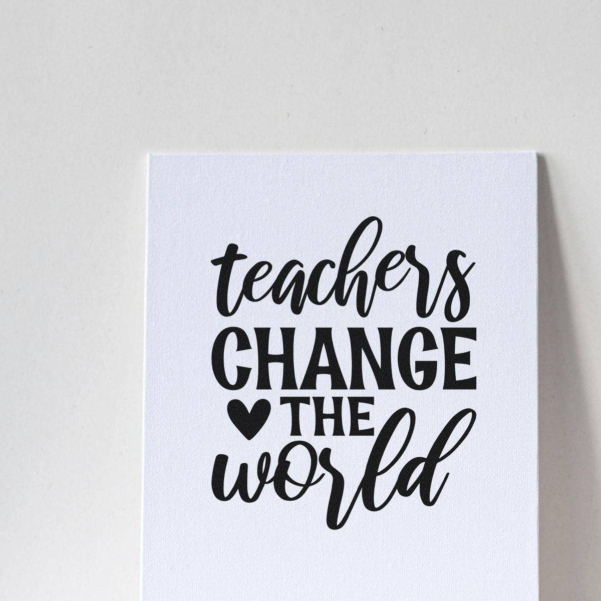 Teachers Change The World Heart Premium Wooden Stamp - Vintage Pro imprint stamped in black ink. "Teachers Change the World" combines script and bold capitals with a solid heart.