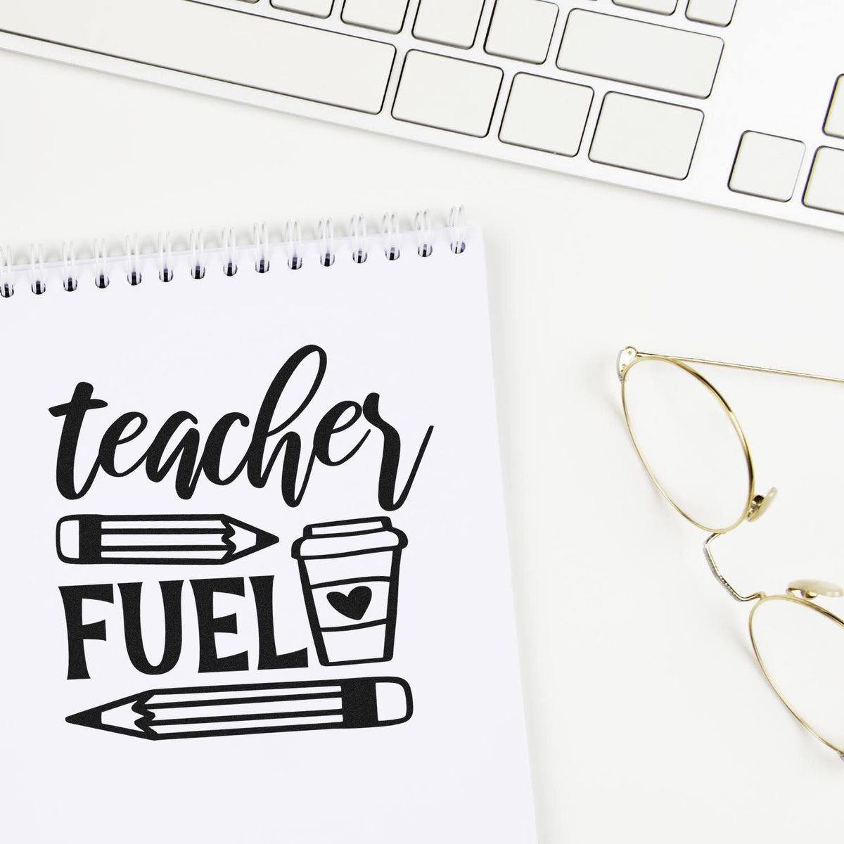 Teacher Fuel Coffee Pencils Premium Wooden Stamp - Vintage Pro imprint stamped in black ink. "Teacher Fuel" appears with two pencils and a takeaway cup with a heart.