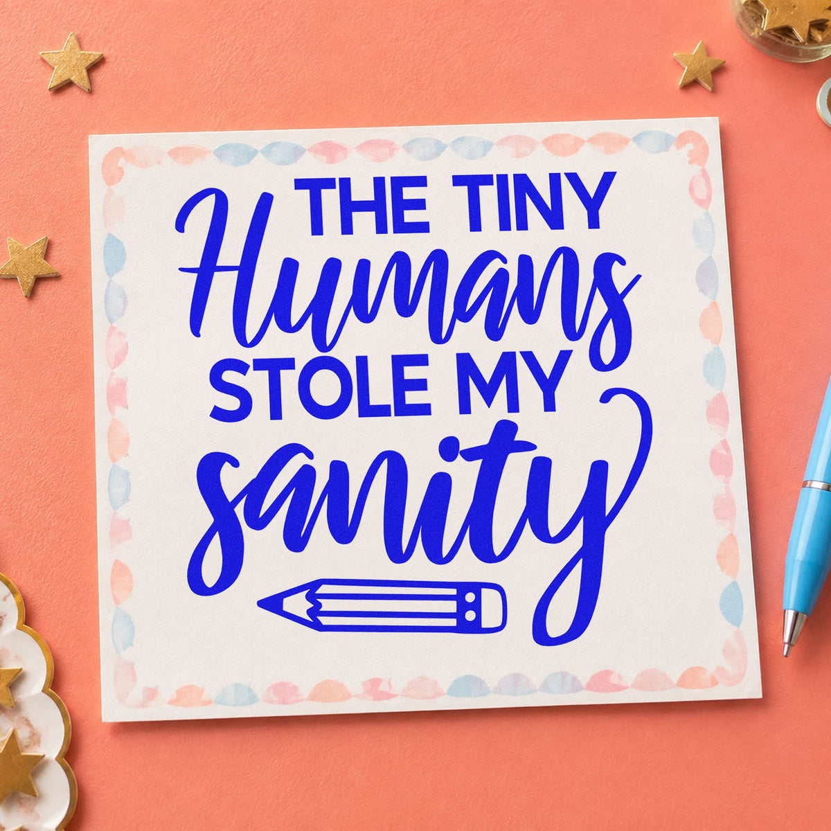 Tiny Humans Stole Sanity craft stamp in blue ink on cardstock, an easy option for bandana edge panels.