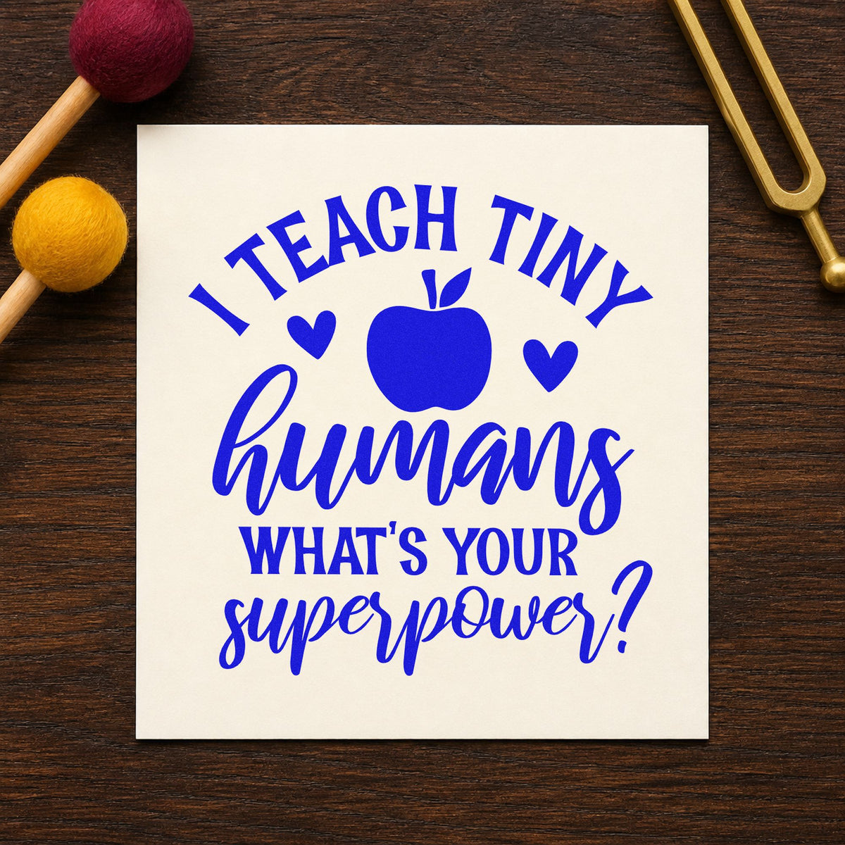 Teach Tiny Humans Superpower craft stamp in blue ink on cardstock, an easy option for tabard front panels.