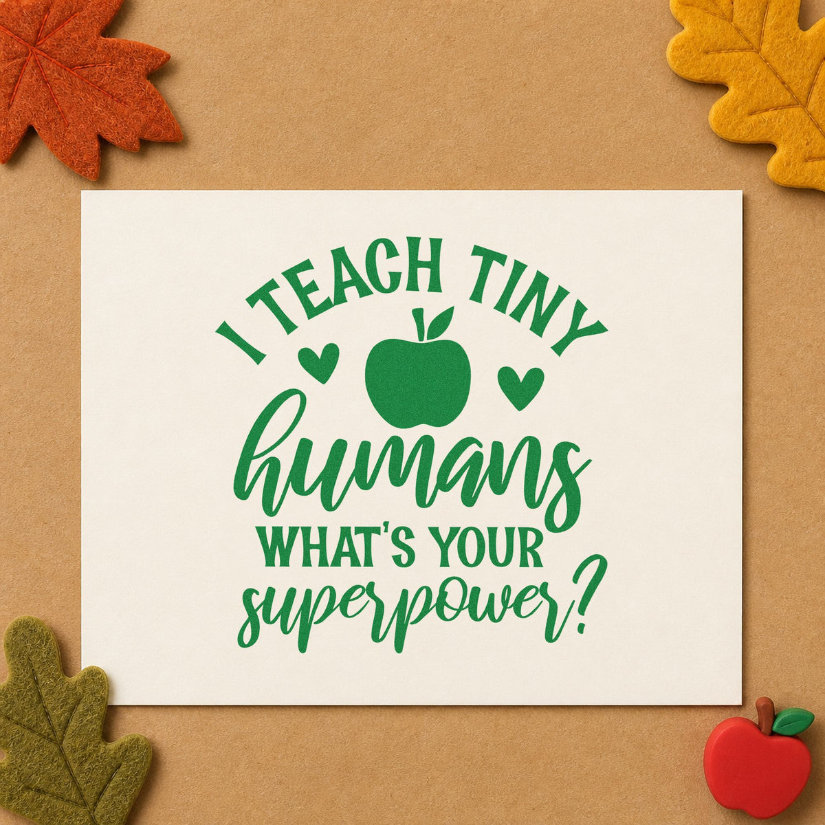 Teach Tiny Humans Superpower craft stamp imprint in green ink on a handmade project, one idea being framed welcome desk.