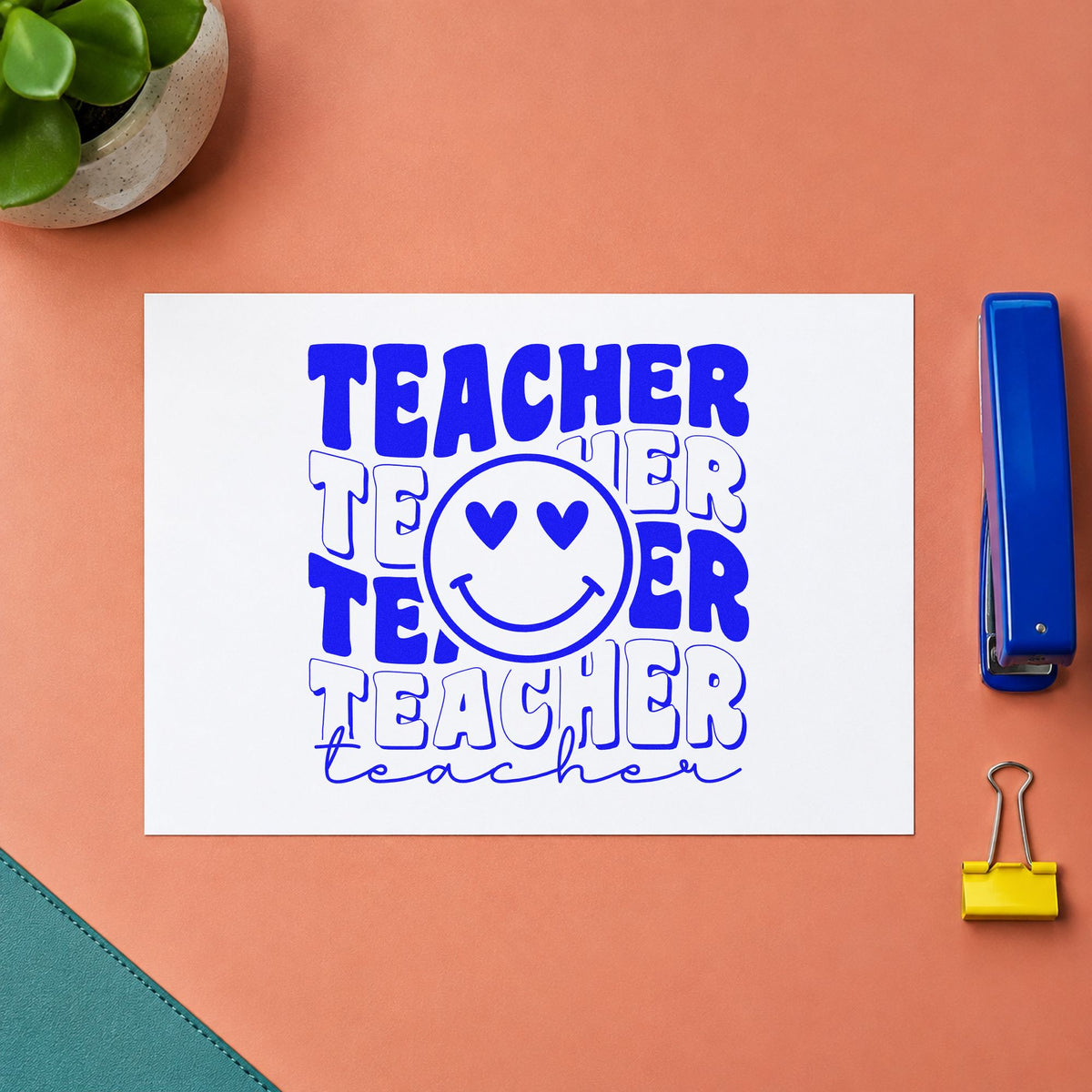 Teacher Repeated Heart Eyed Smile craft stamp imprinted in blue ink on paper, a design suited to sticker roll seals.