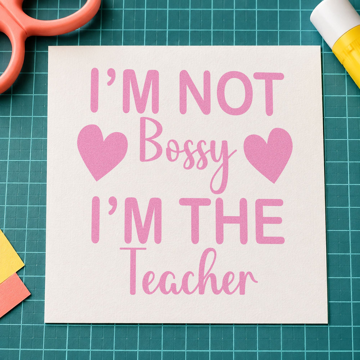 Not Bossy I'm The Teacher craft stamp in purple ink on cardstock, an easy option for rota board tags.