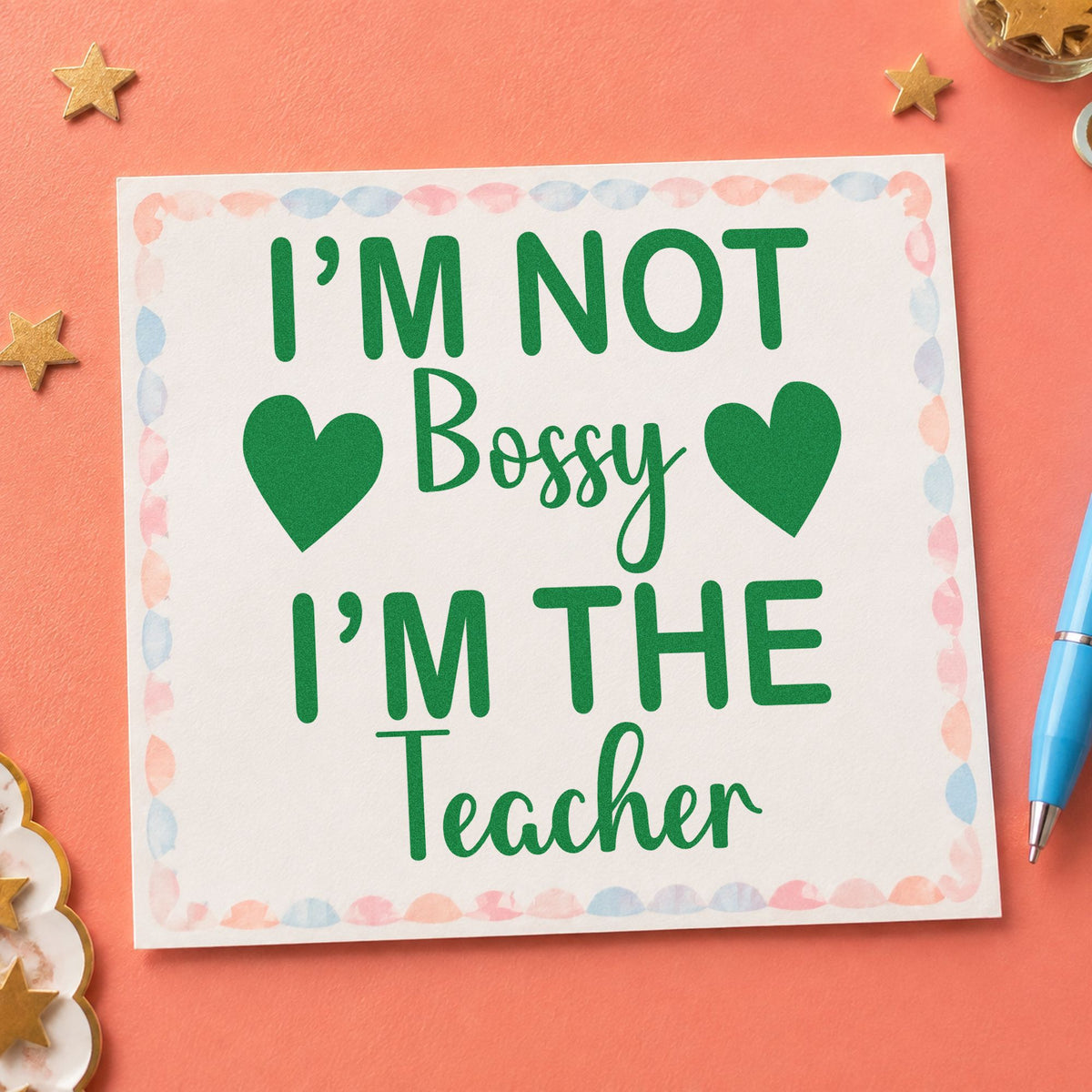 Not Bossy I'm The Teacher craft stamp imprint in green ink on a handmade project, one idea being instruction pages.