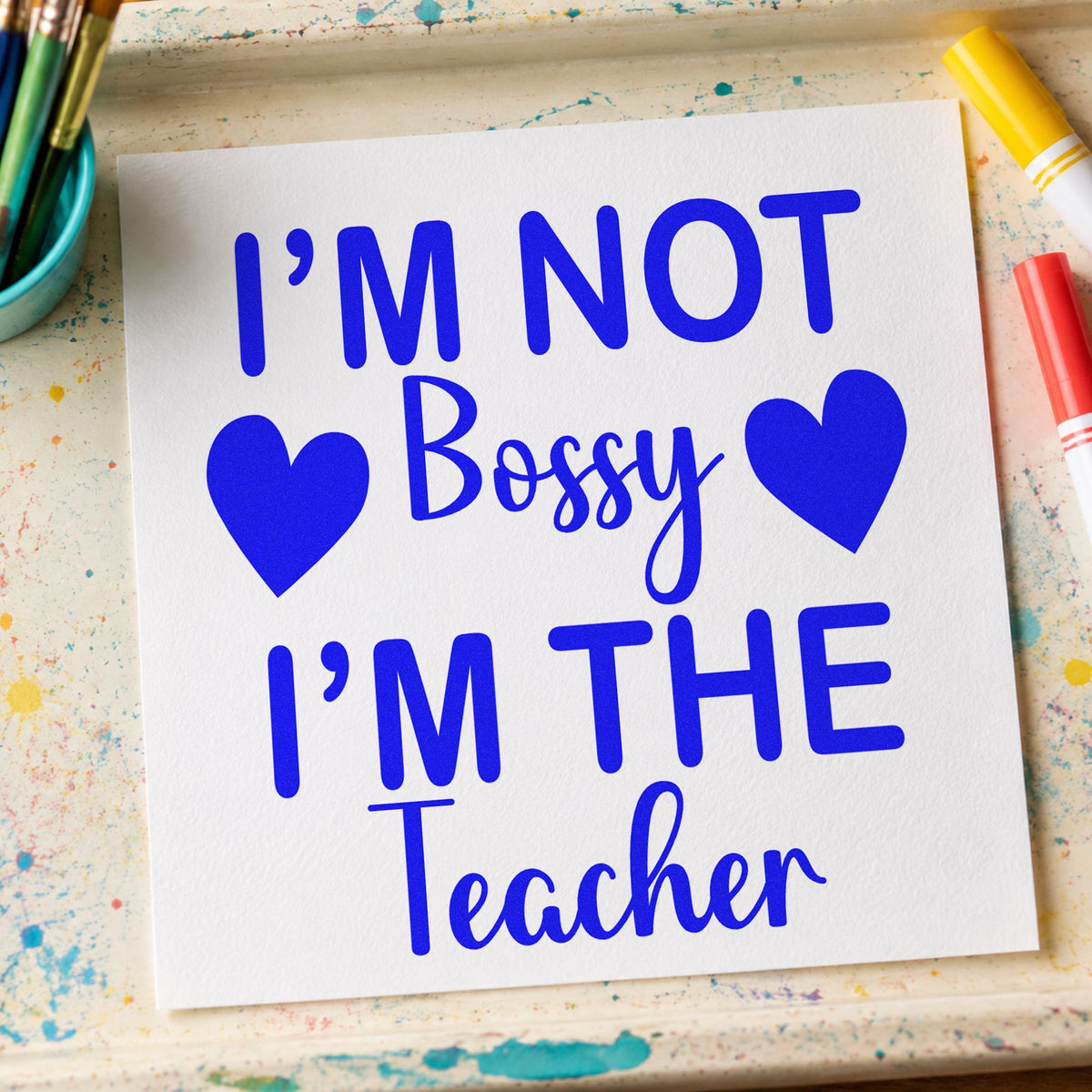 Not Bossy I'm The Teacher craft stamp in blue ink on cardstock, an easy option for whistle loop panels.