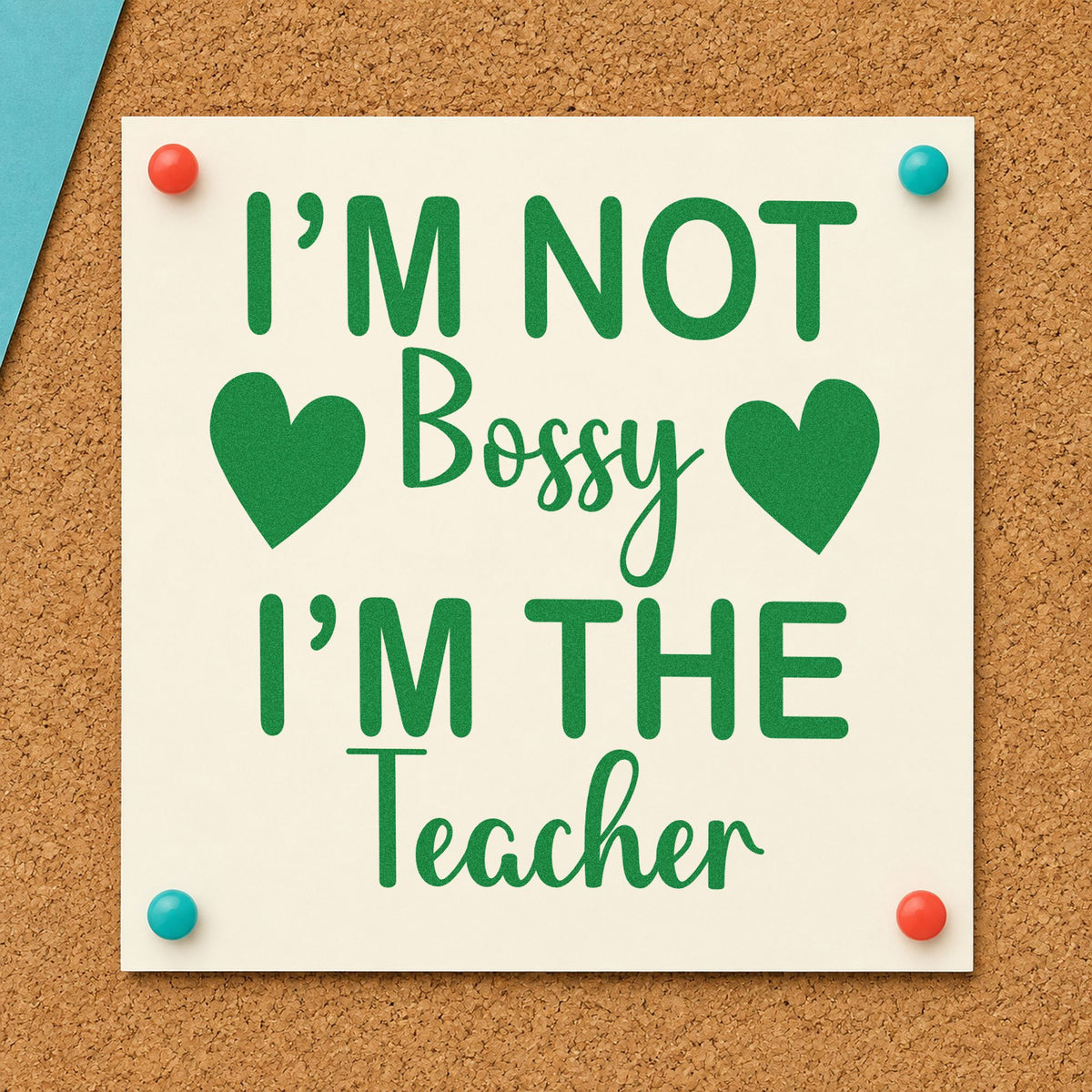 Not Bossy I'm The Teacher craft stamp imprint in green ink on a handmade project, one idea being framed rota corner.