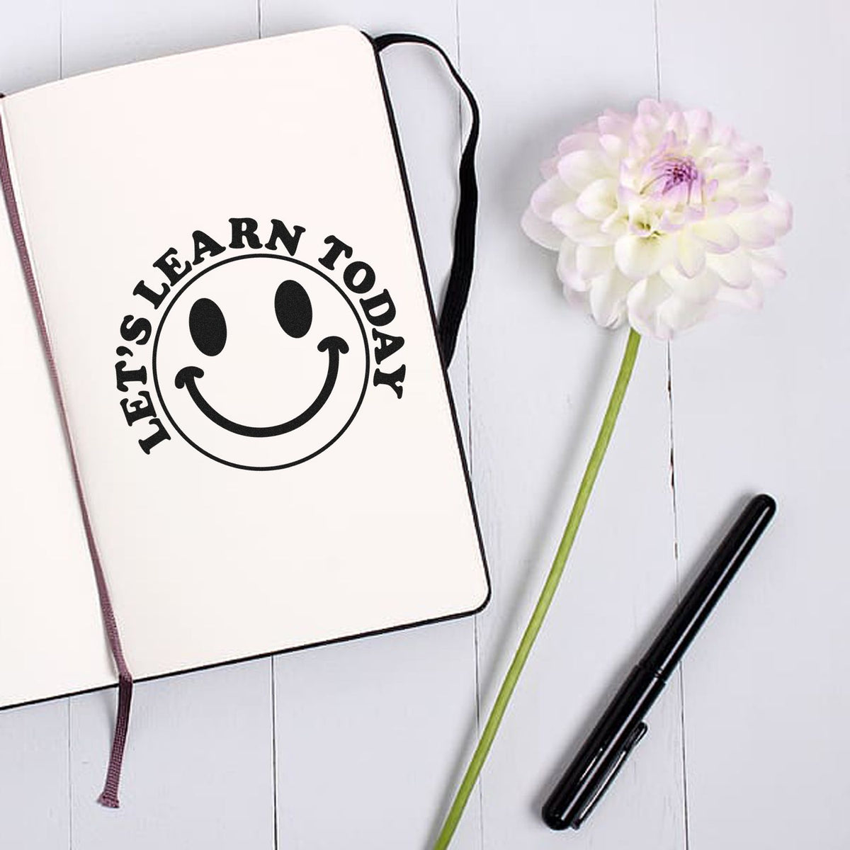 Vintage Pro Learn Today Smiley Word Art Premium Wooden Stamp imprint stamped in black ink. "Let's Learn Today" curves around a large smiling face.