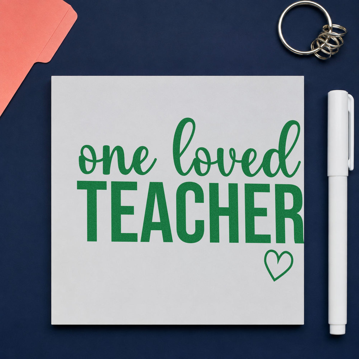 One Loved Teacher craft stamp imprint in green ink on a handmade project, one idea being citation pages.