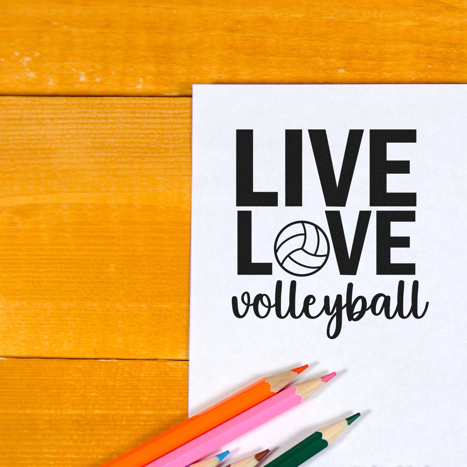 Live Love Volleyball rubber stamp design on paper with colored pencils, ideal for sports crafts and team fan projects.