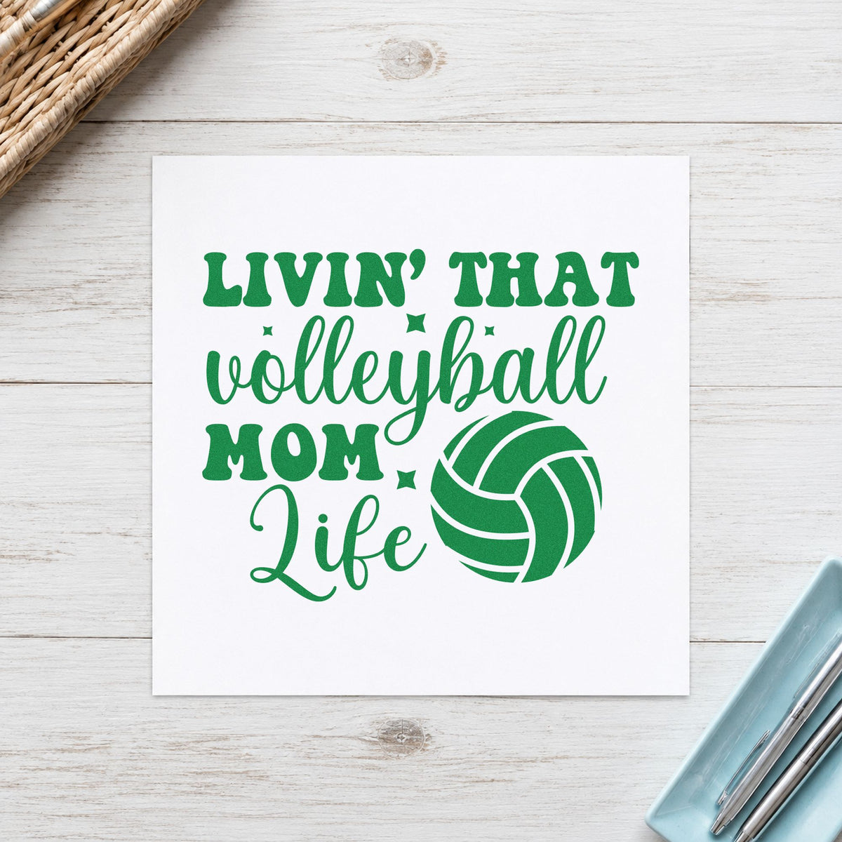 Livin That Volleyball Mom Life craft stamp imprint in green ink on a handmade project, one idea being hotel plan pages.