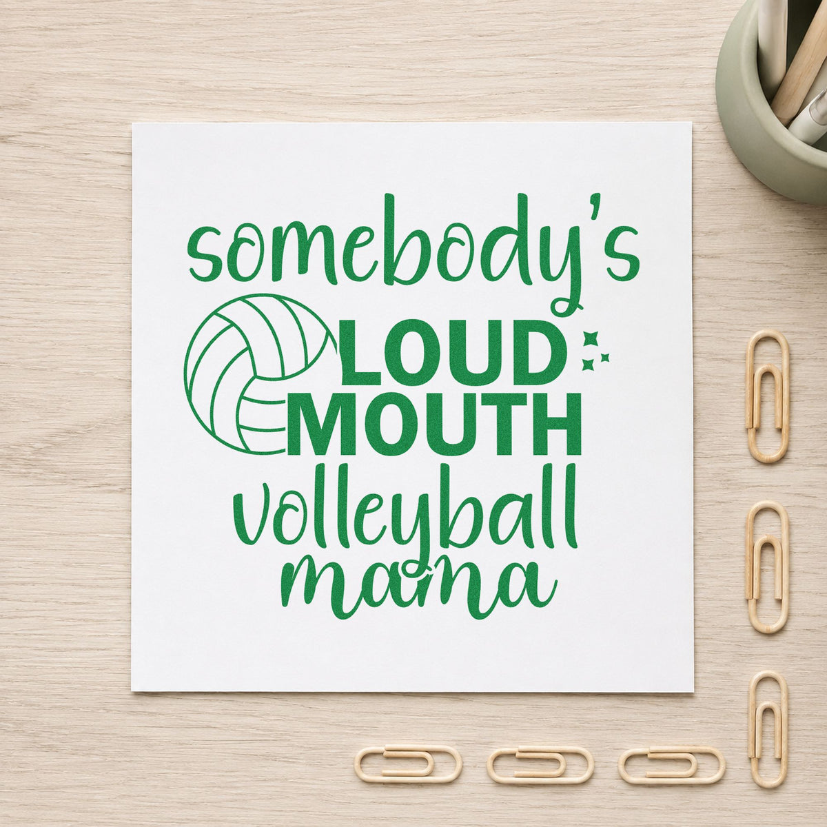 Loud Mouth Volleyball Mama craft stamp imprint in green ink on a handmade project, one idea being framed stands corner.