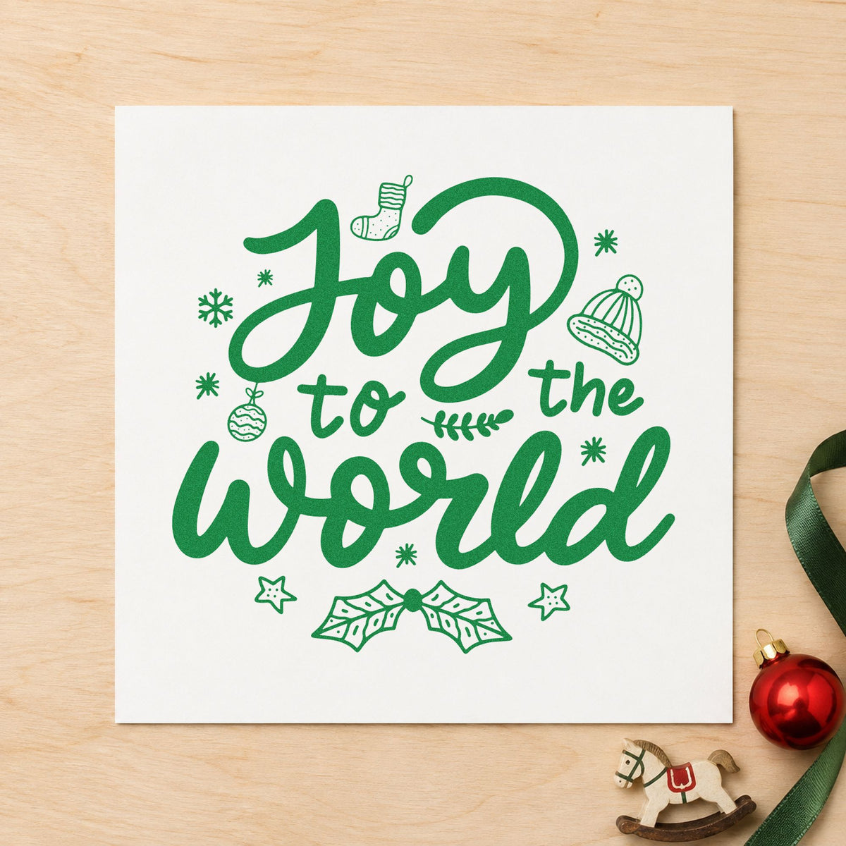 Joy To The World craft stamp imprint in green ink on a handmade project, one idea being ornament crafts.