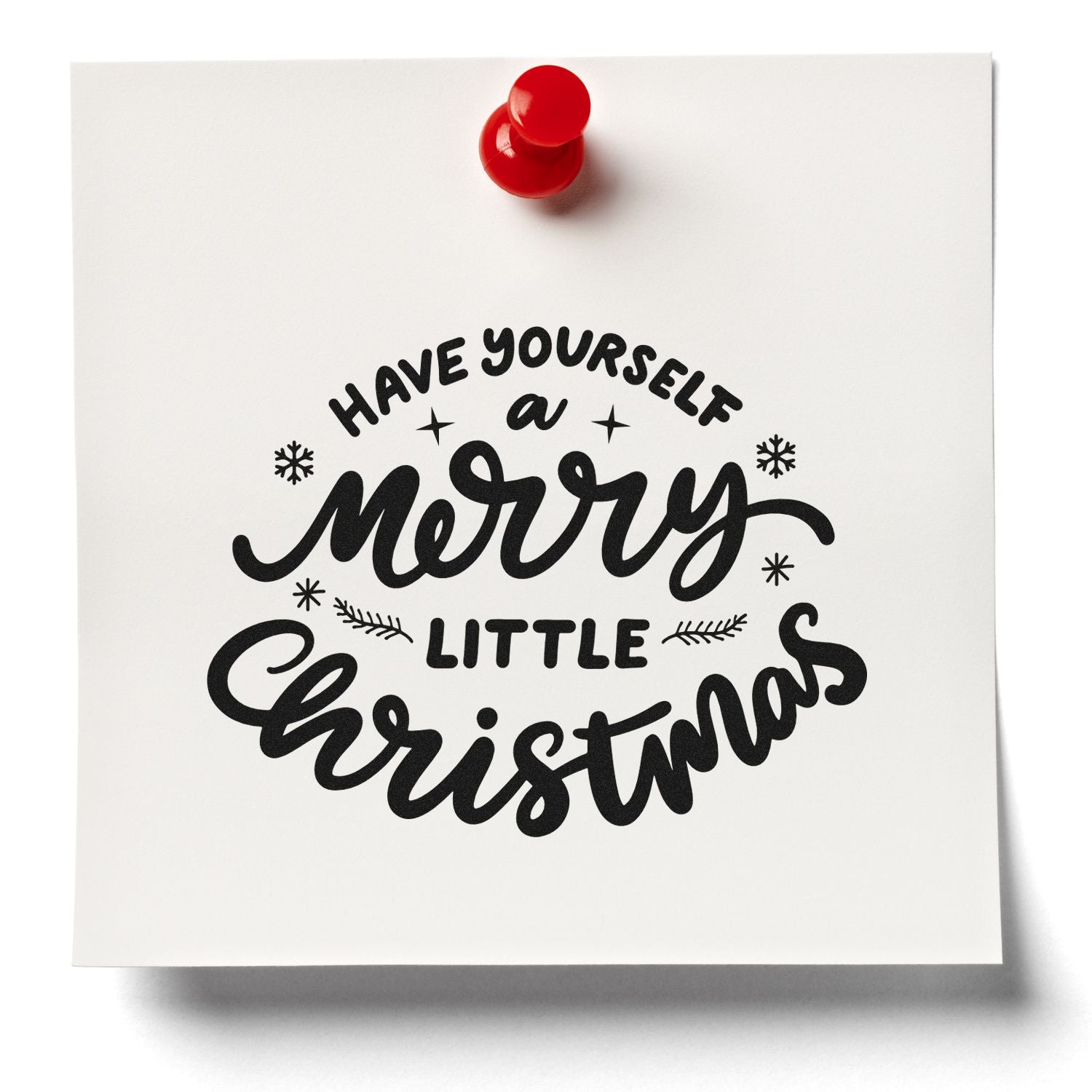 Holiday rubber stamp design reading Have Yourself a Merry Little Christmas on white card with red pushpin.