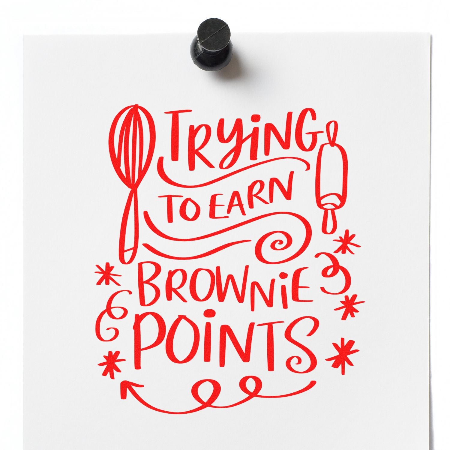Rubber stamp design reading Trying to earn brownie points with whisk and rolling pin for baking-themed crafts.