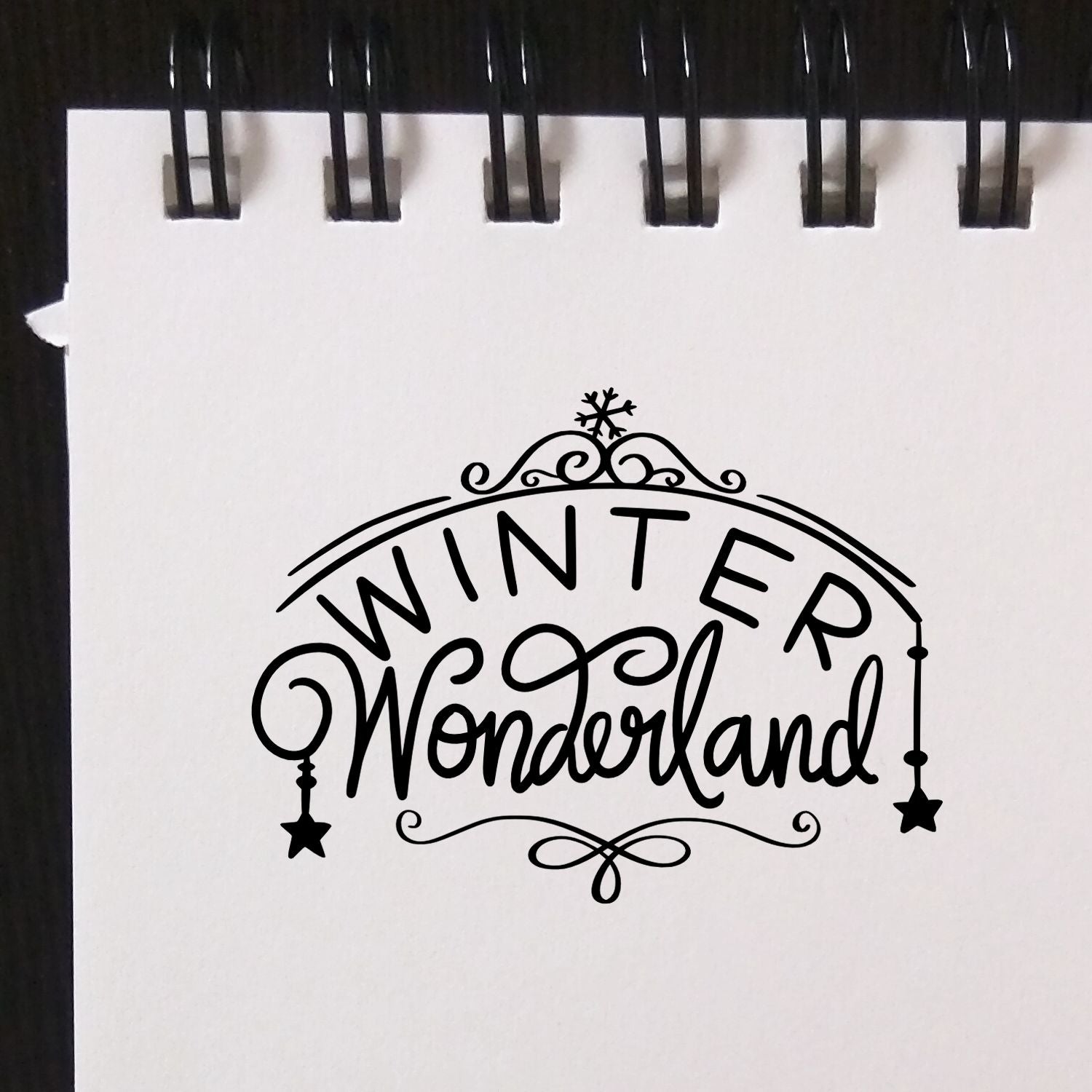 Winter Wonderland decorative rubber stamp design for holiday cards, with elegant script, snowflake, and ornate festive accents.