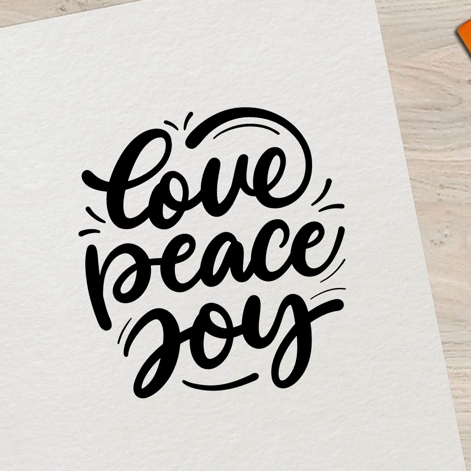 Love Peace Joy rubber stamp in decorative script on paper, ideal for handmade cards, crafts, and inspirational stamping.