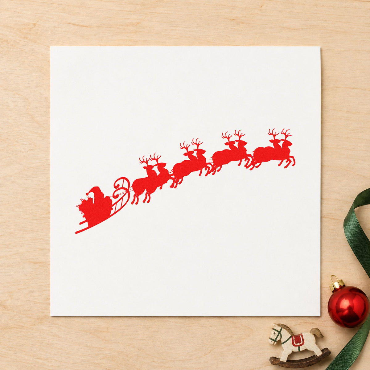 Santa Sleigh And Reindeer rubber stamp shown in red ink, stamped for projects such as tracking eve notes.