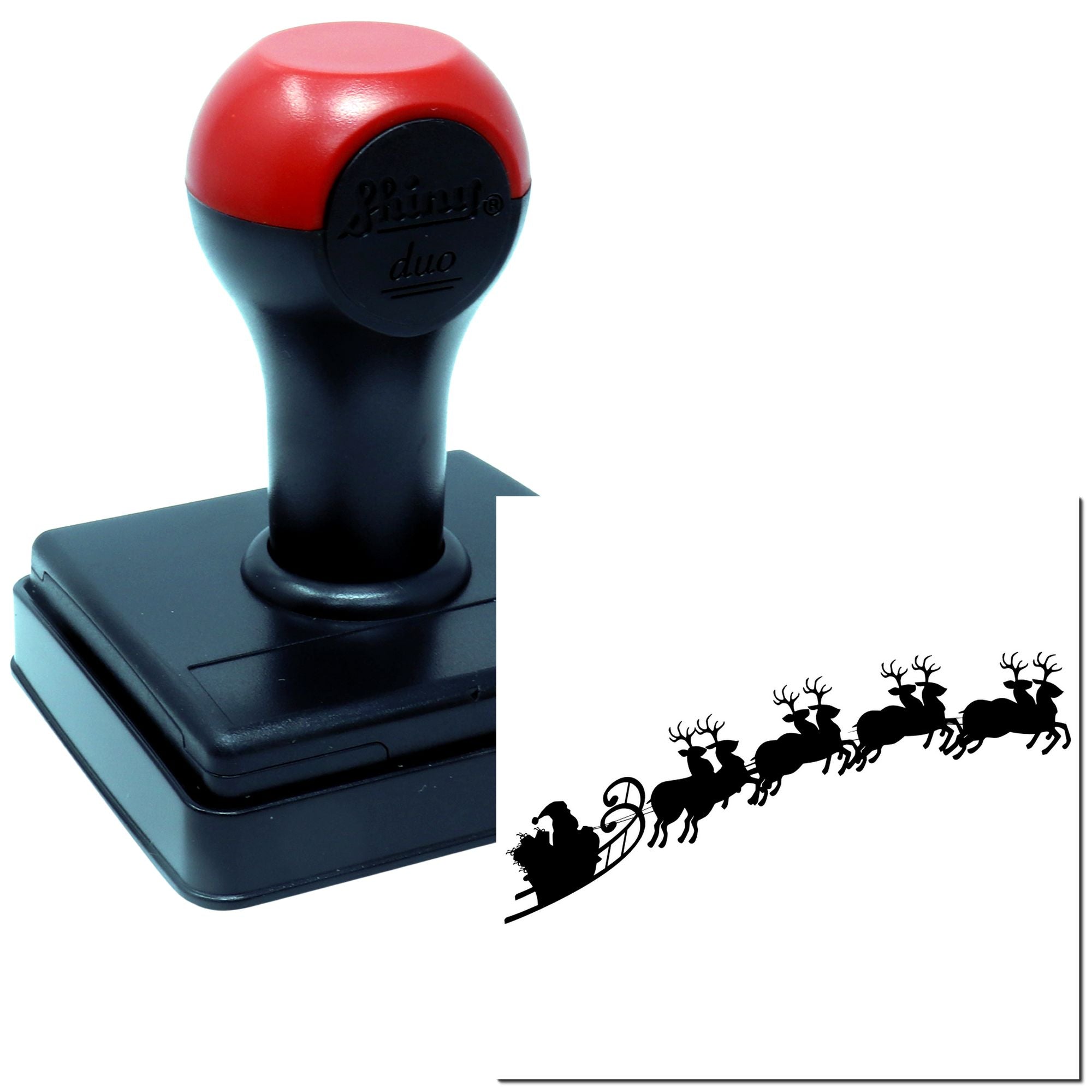 Self-inking rubber stamp for holiday crafts, stamping a Santa sleigh and reindeer silhouette design.