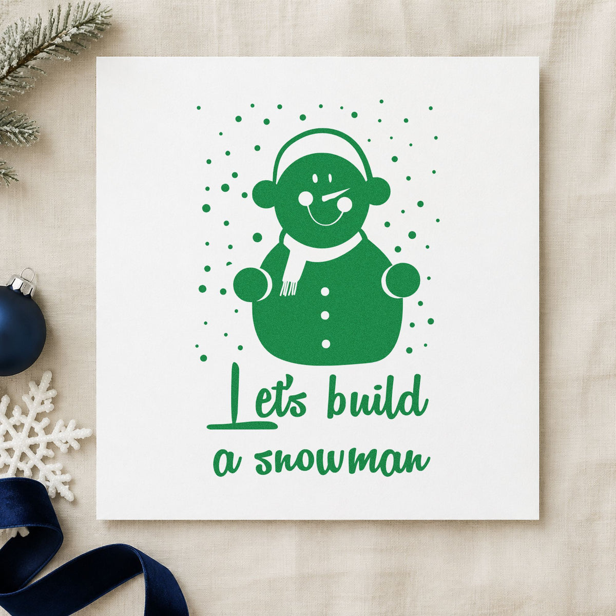 Let's Build A Snowman craft stamp imprinted in green ink on paper, a design suited to kit bag seals.