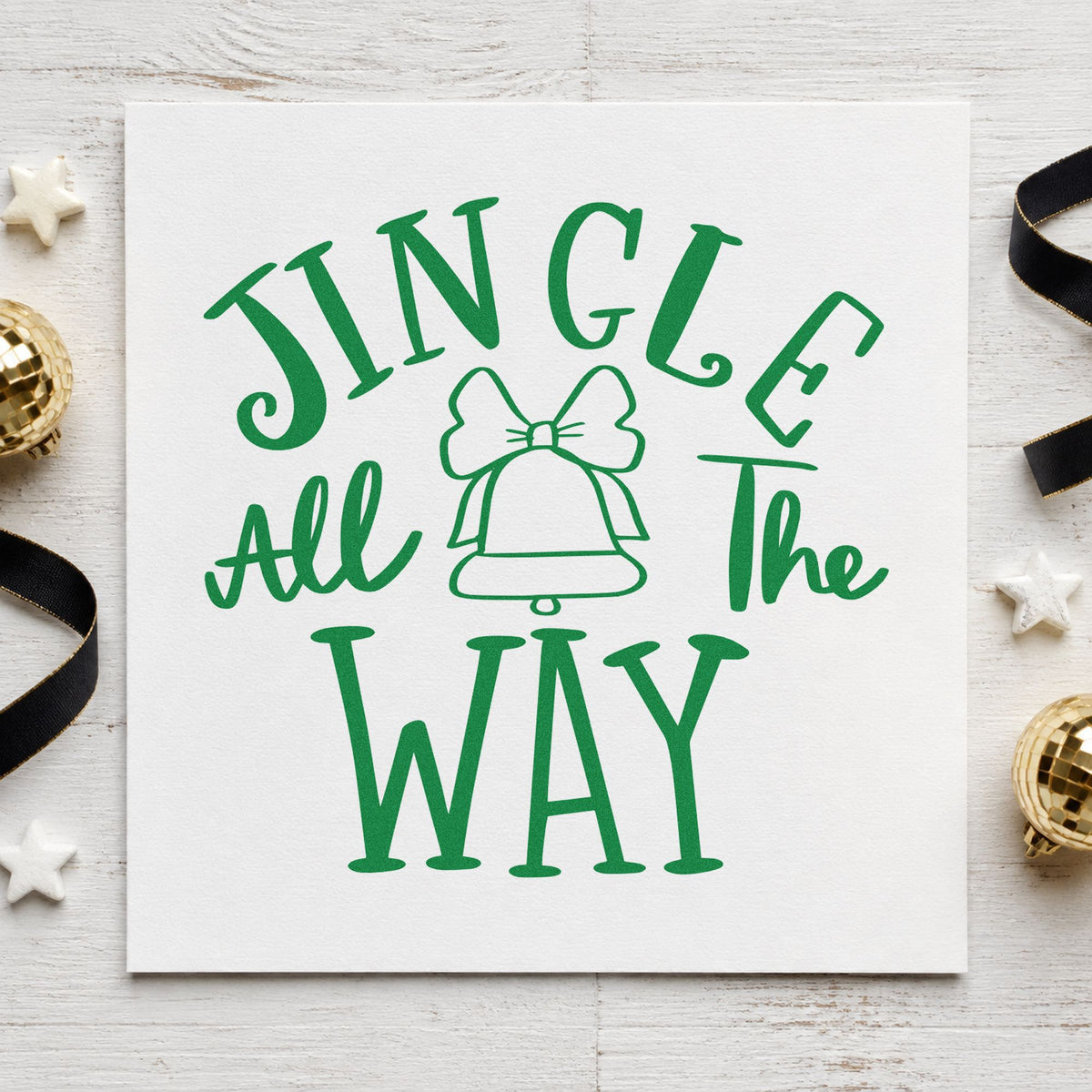 Jingle All The Way Bell craft stamp imprint in green ink on a handmade project, one idea being hayride wristbands.