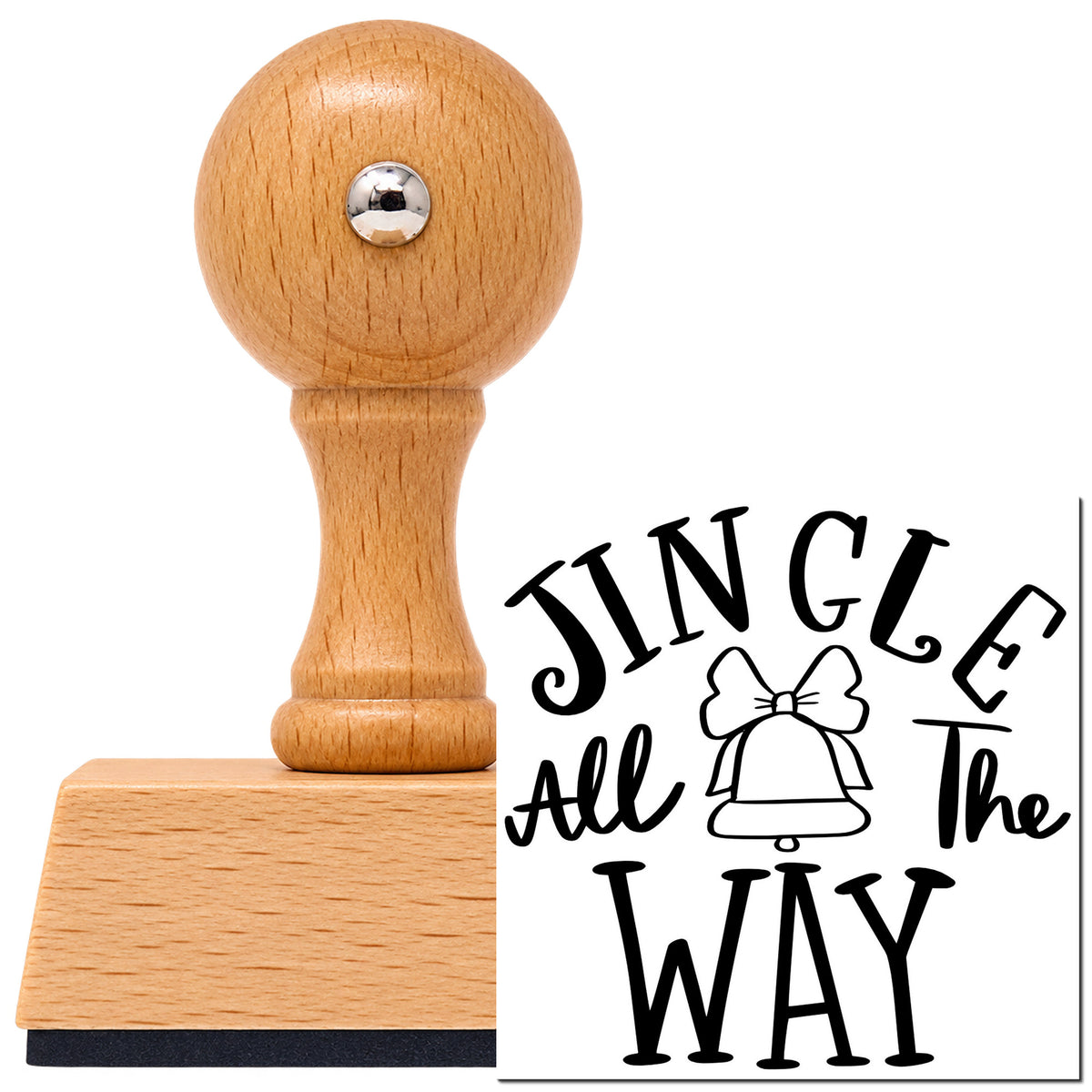 Jingle All The Way Bell Vintage Pro rubber stamp in European beech wood with a round knob handle, shown beside its black imprint.