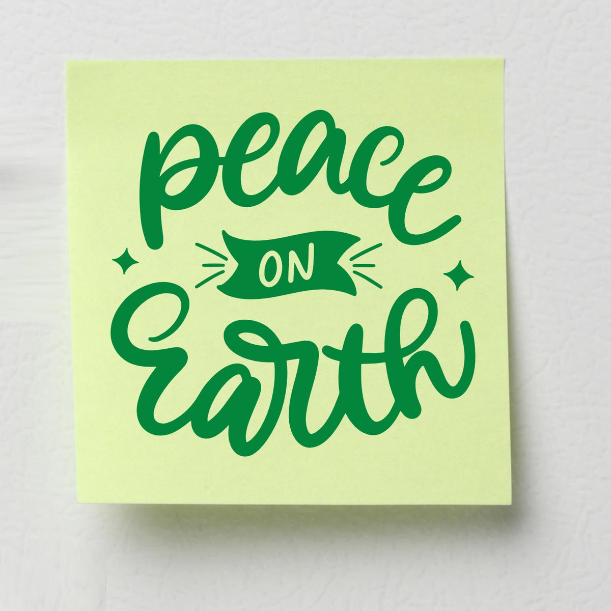 Peace On Earth Banner rubber stamp shown in green ink, stamped for projects such as memory book opener.