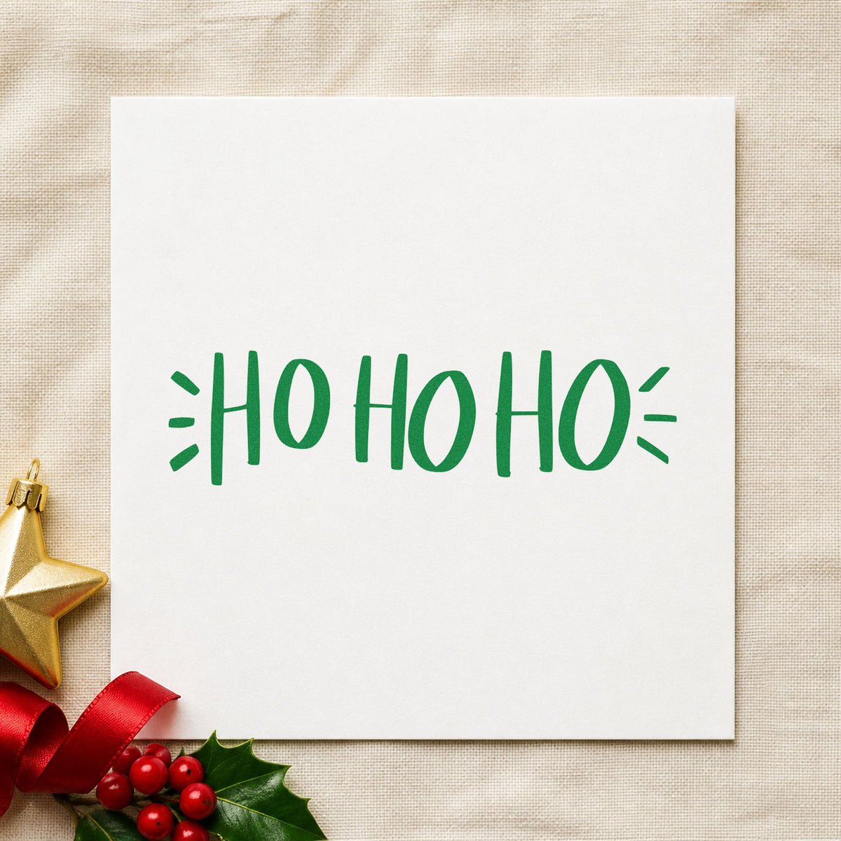 Ho Ho Ho Lettering craft stamp imprint in green ink on a handmade project, one idea being stocking name tags.