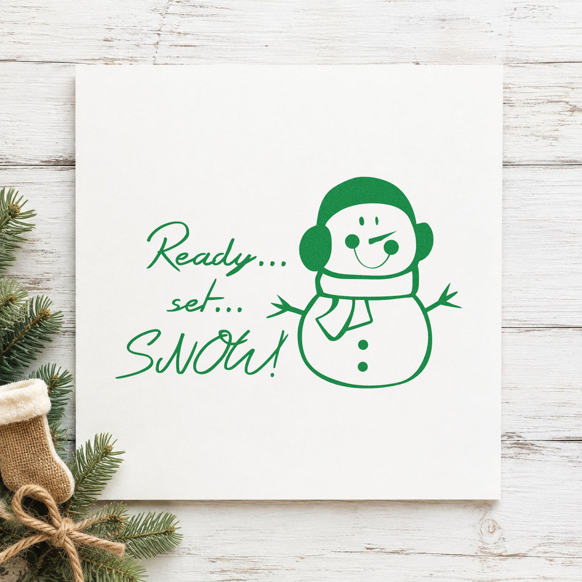 Ready Set Snow Snowman craft stamp imprint in green ink on a handmade project, one idea being hot drink cup tags.