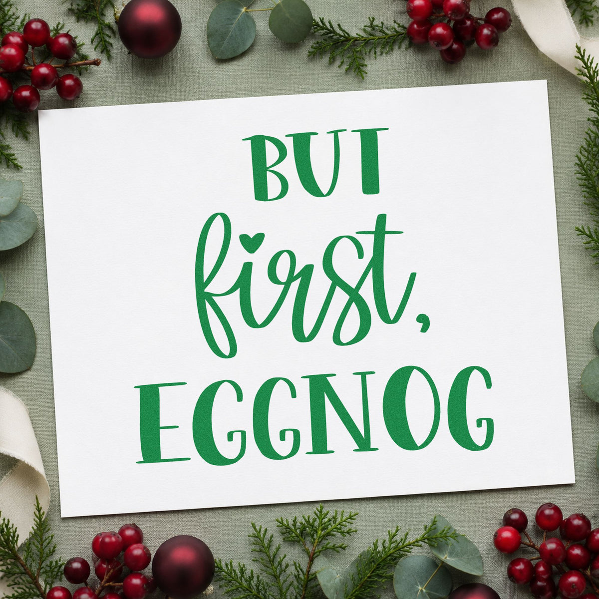 But First Eggnog craft stamp imprinted in green ink on paper, a design suited to framed serving nook.