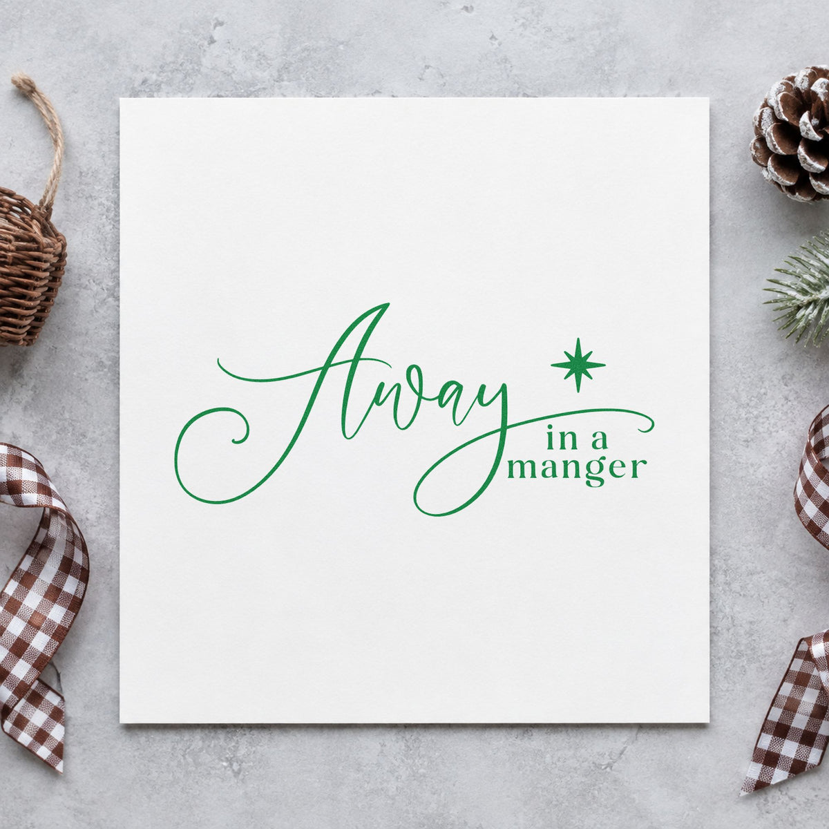 Away In A Manger craft stamp imprinted in green ink on paper, a design suited to framed classroom door.