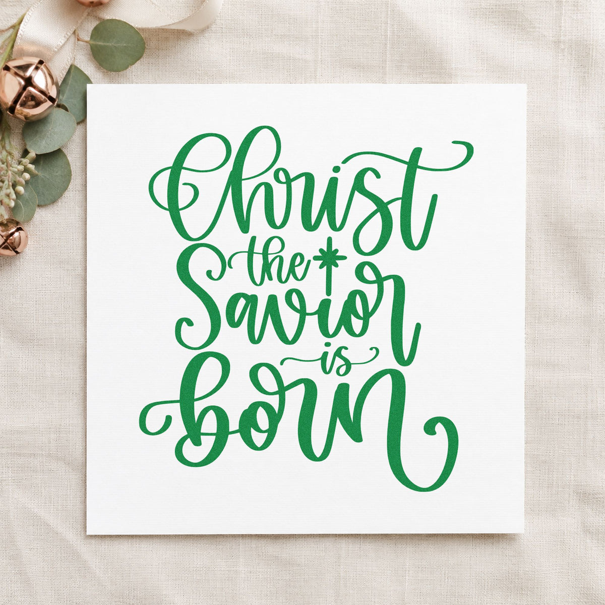 Christ The Savior Is Born craft stamp imprint in green ink on a handmade project, one idea being hymnal gift tags.