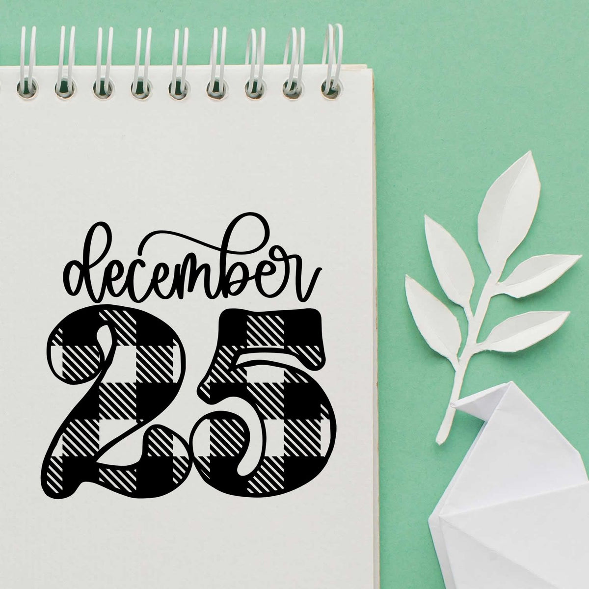 Vintage Pro December Twenty Five Plaid Premium Wooden Stamp imprint stamped in black ink. Script "December" sits above large plaid-patterned numerals "25."