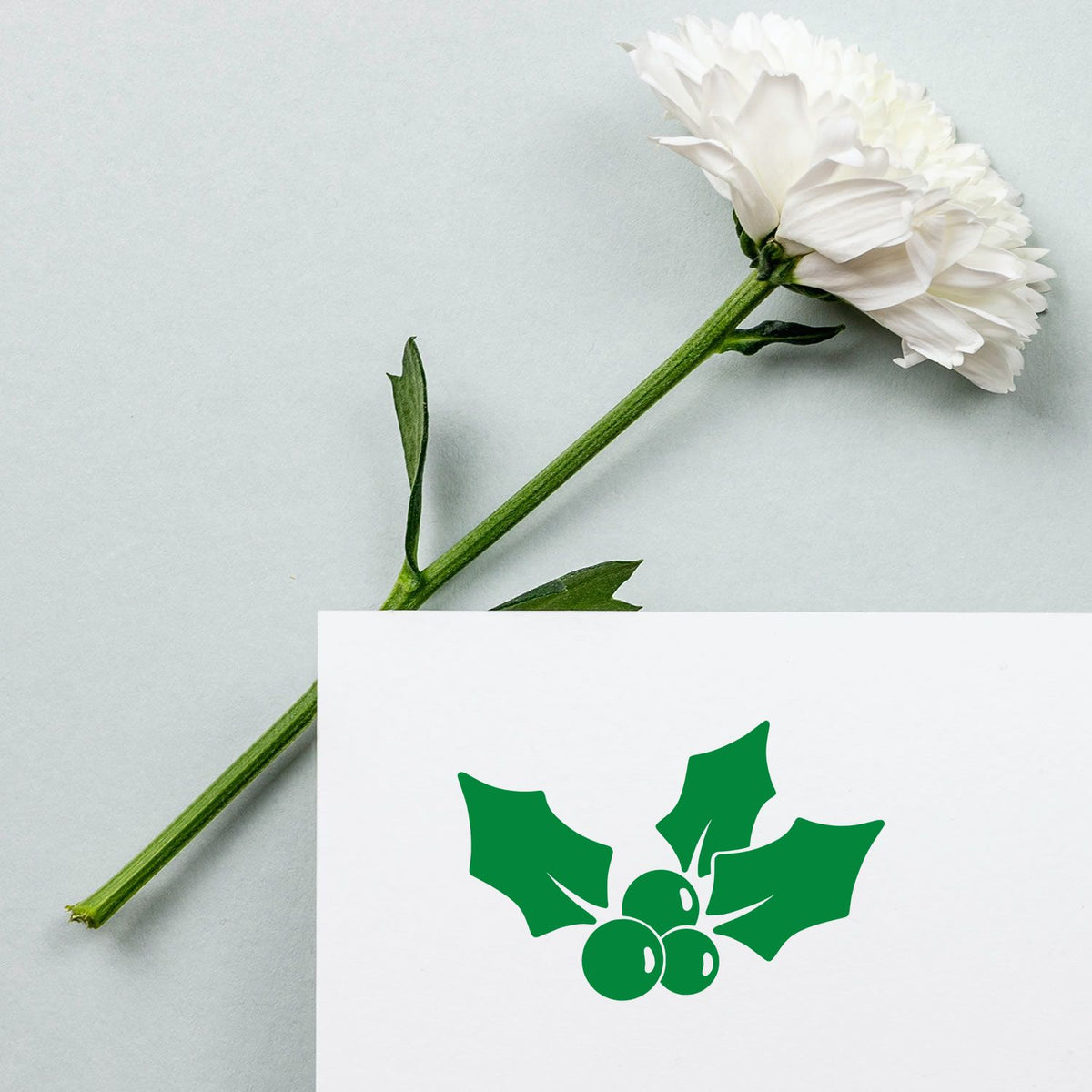 Three Leaf Holly Sprig rubber stamp shown in green ink, stamped for projects such as border pattern paper.