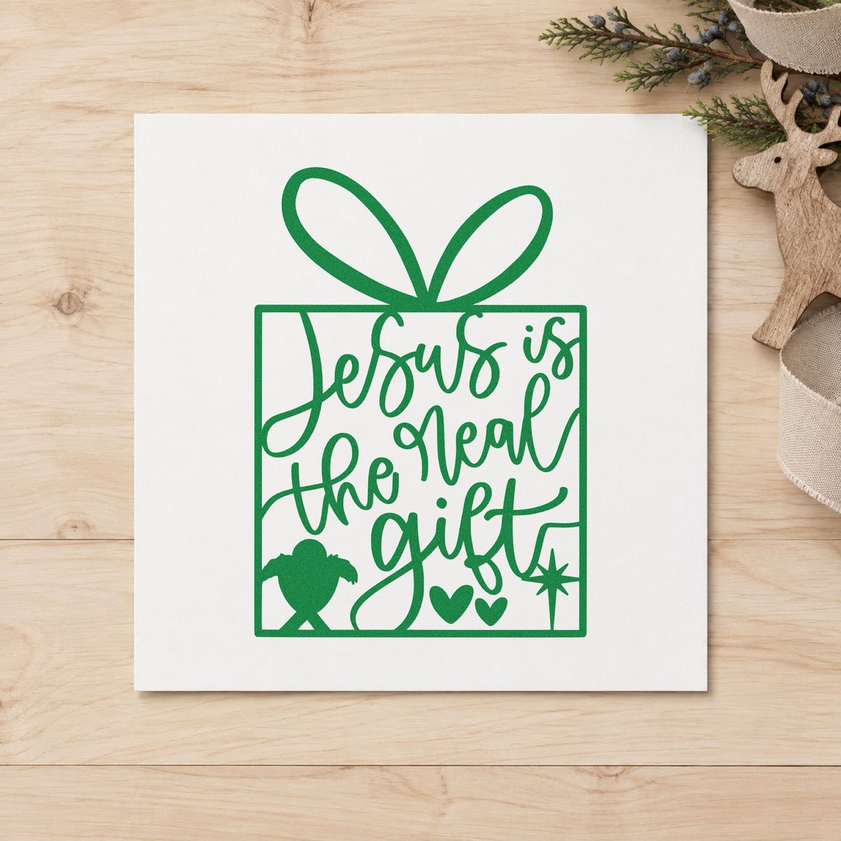 Jesus Is The Real Gift craft stamp imprint in green ink on a handmade project, one idea being angel tree tags.