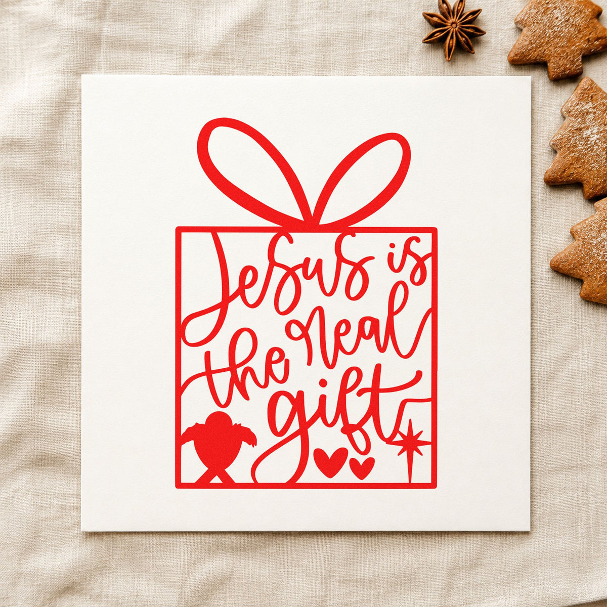 Jesus Is The Real Gift craft stamp in red ink on cardstock, an easy option for collection bag ink.