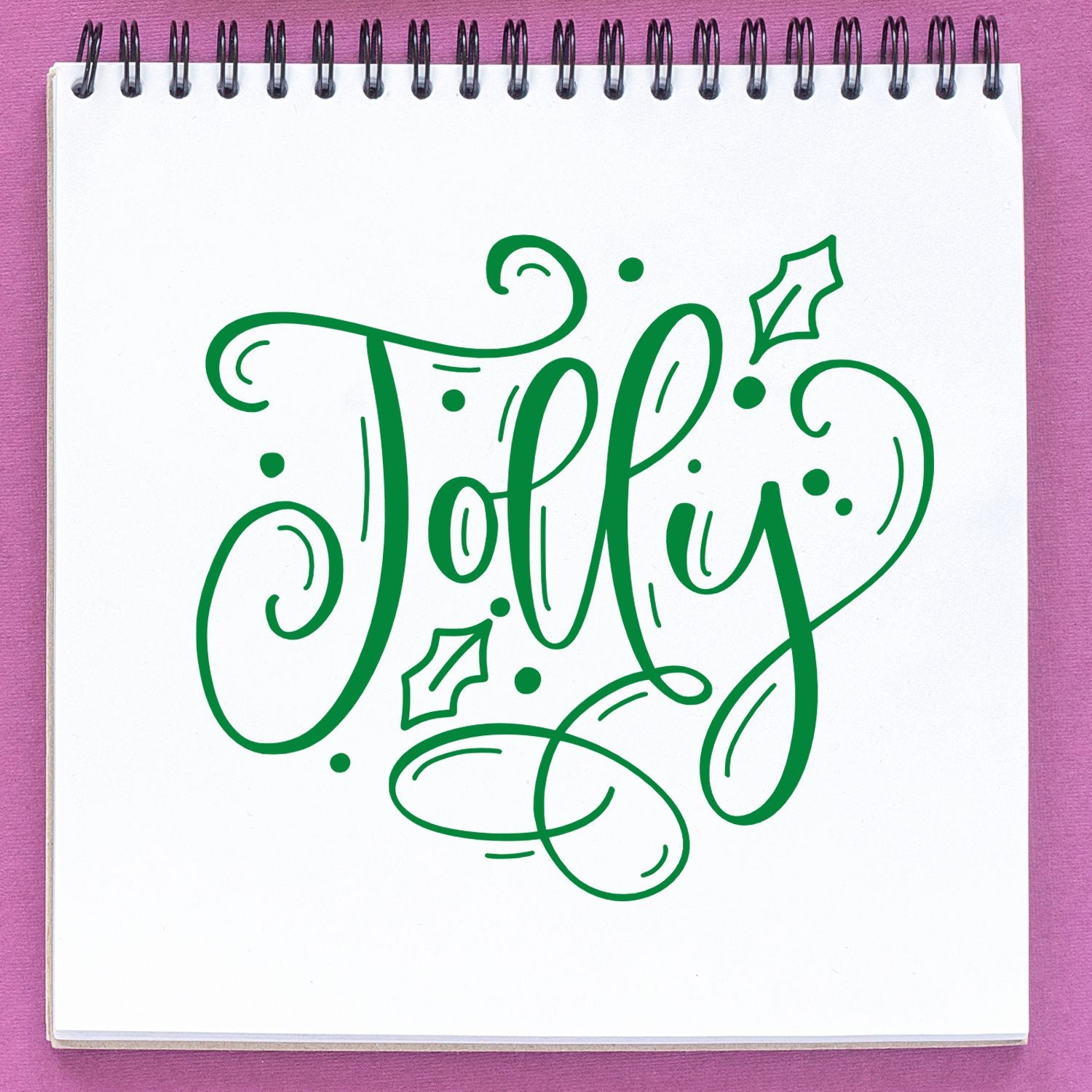 Jolly holiday rubber stamp design in green script with holly accents, perfect for Christmas crafts.
