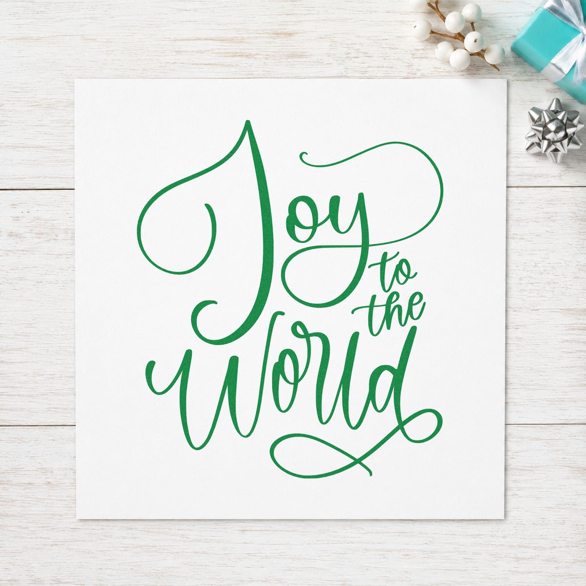 Joy To The World Thin Script craft stamp imprinted in green ink on paper, a design suited to framed powder room.