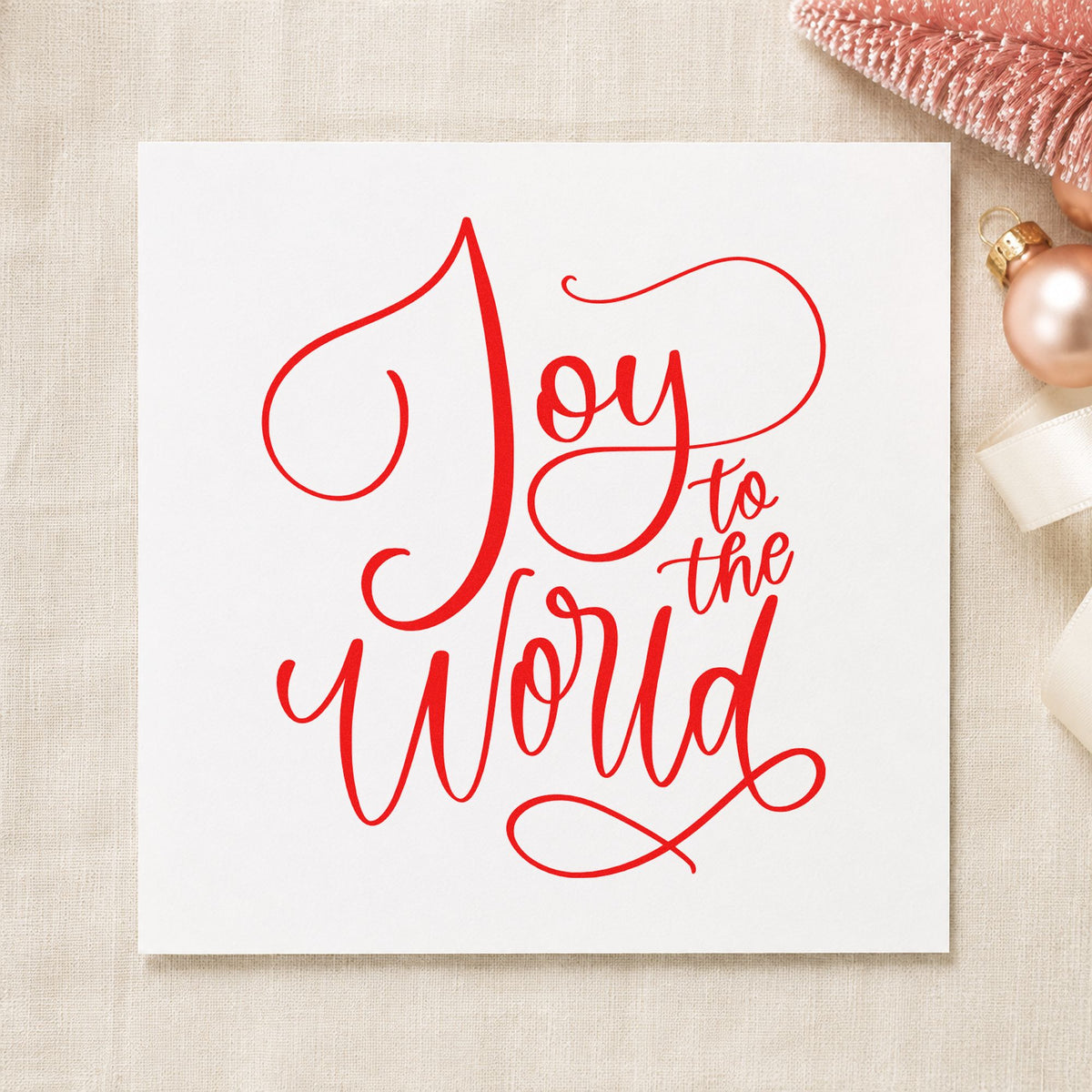 Joy To The World Thin Script rubber stamp shown in red ink, stamped for projects such as perfume box seals.
